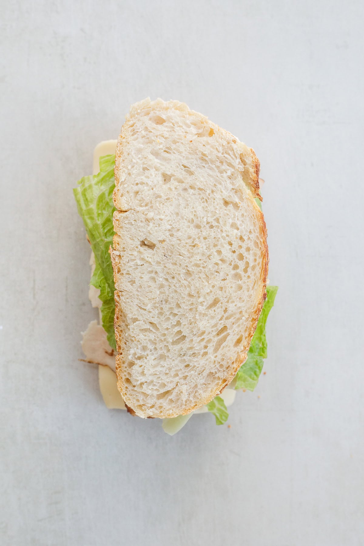 Our version of a turkey sandwich features crispy bacon and a homemade spread, making for an incredible lunch. The closed turkey sandwich.