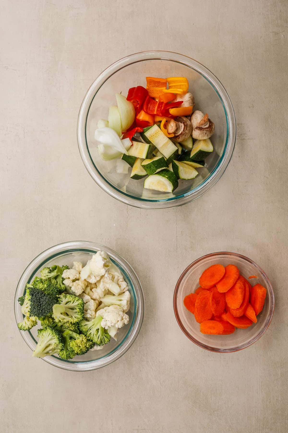These sauteed vegetables make the perfect quick and easy side dish. Glass bowls with vegetables for veggie stir fry.
