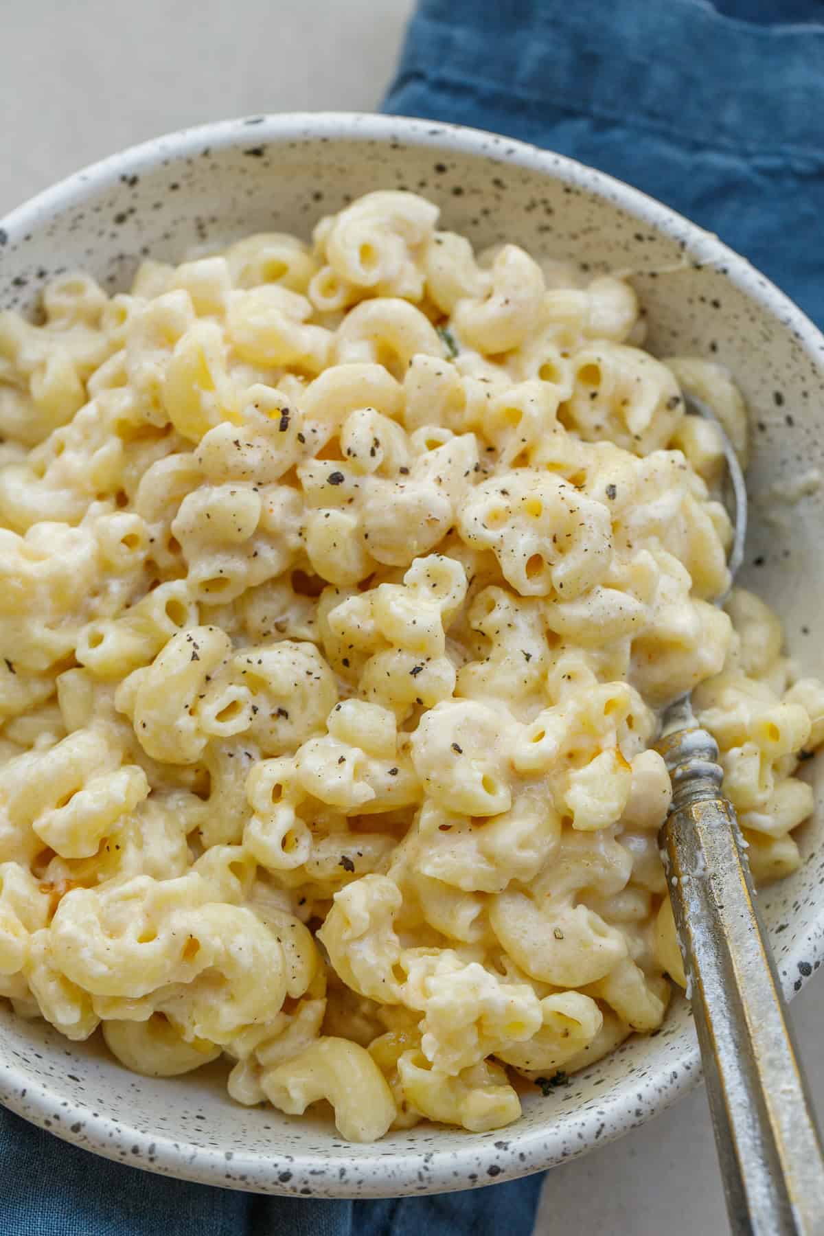 This classic crockpot mac and cheese recipe is packed with loads of cheeses. The result is the perfect comfort meal in just the slow cooker. A bowl of rich and creamy mac and cheese.