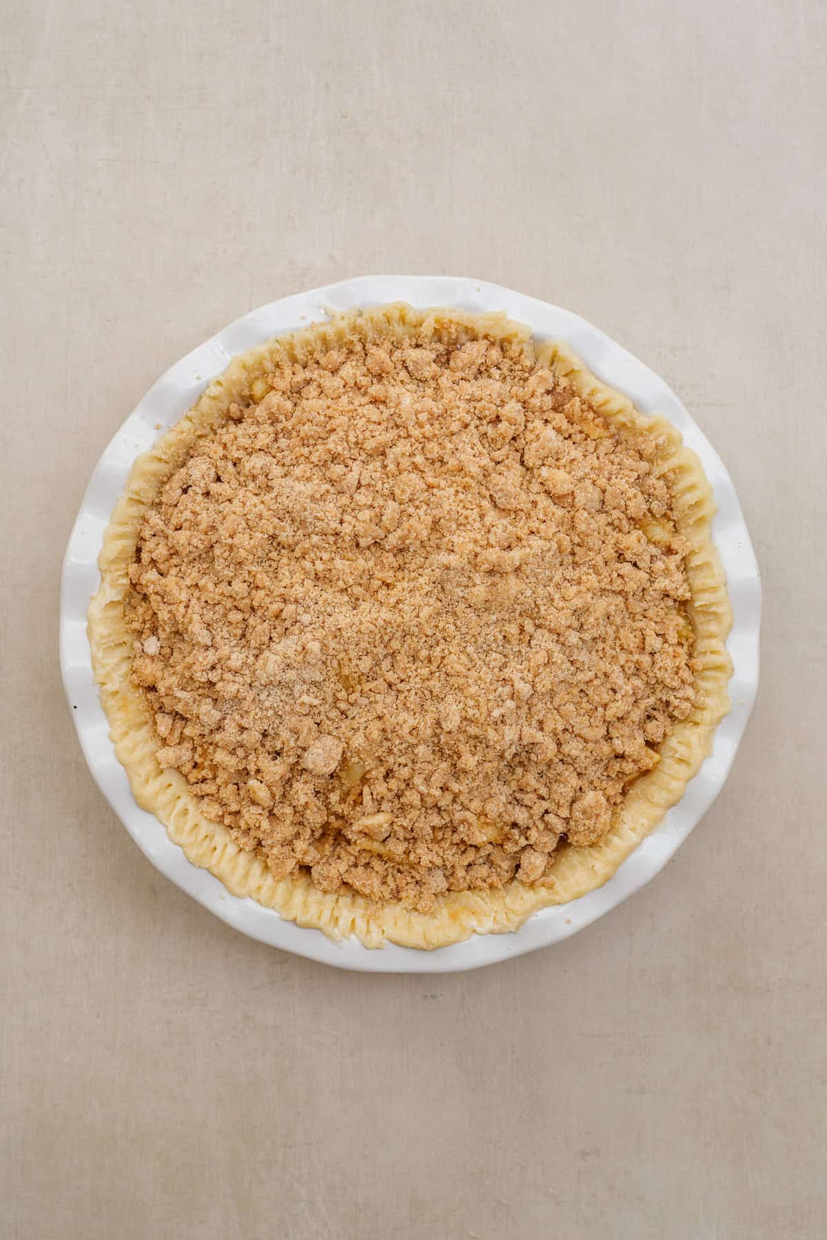 A simple dutch apple pie is packed with flavor and makes the perfect dessert. A pie dish with the apple pie and crumb topping.