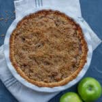 A pie dish with a baked dutch apple pie