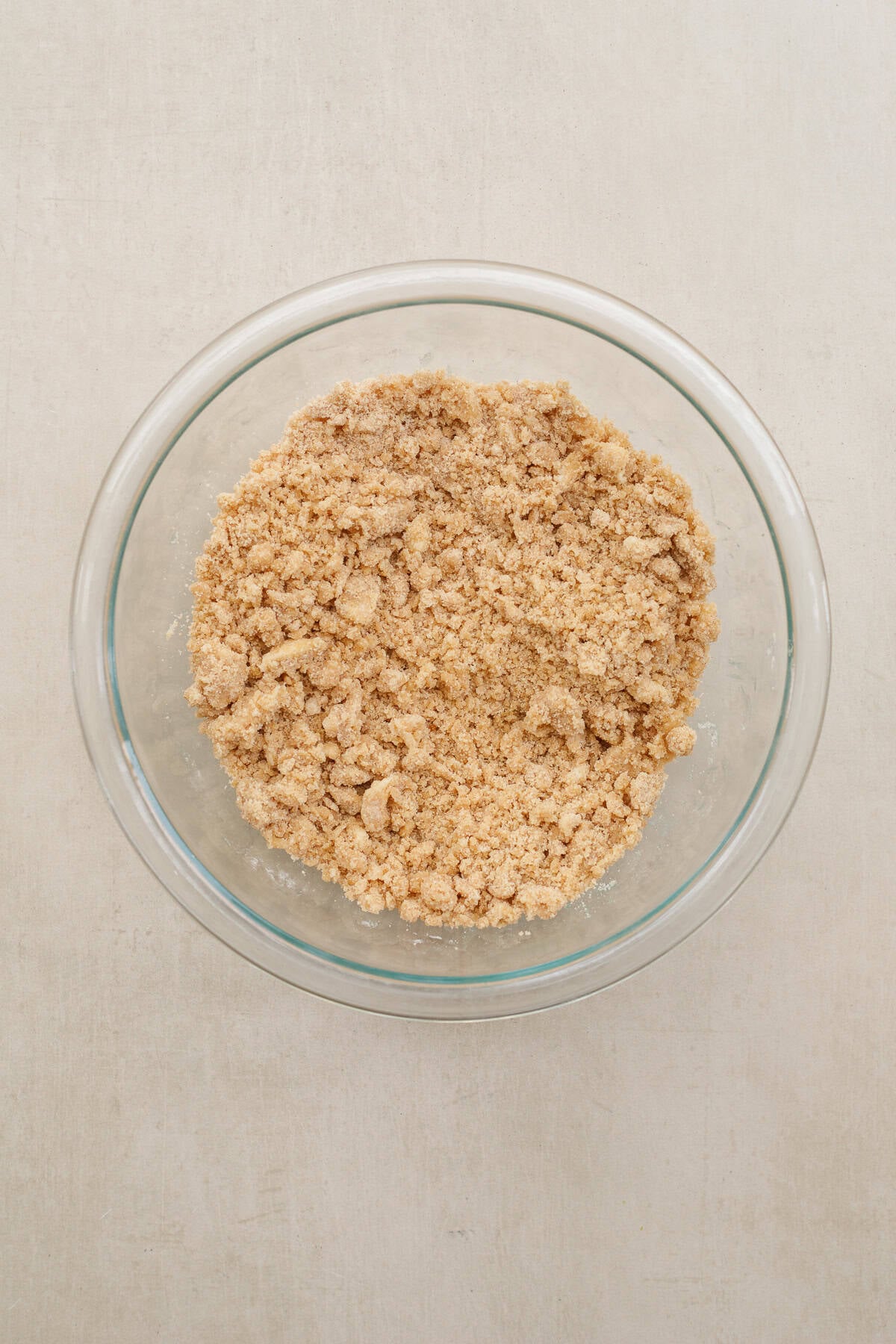 A homemade streusel is the finishing touch to this dutch apple pie recipe. A glass bowl with the streusel toppings.