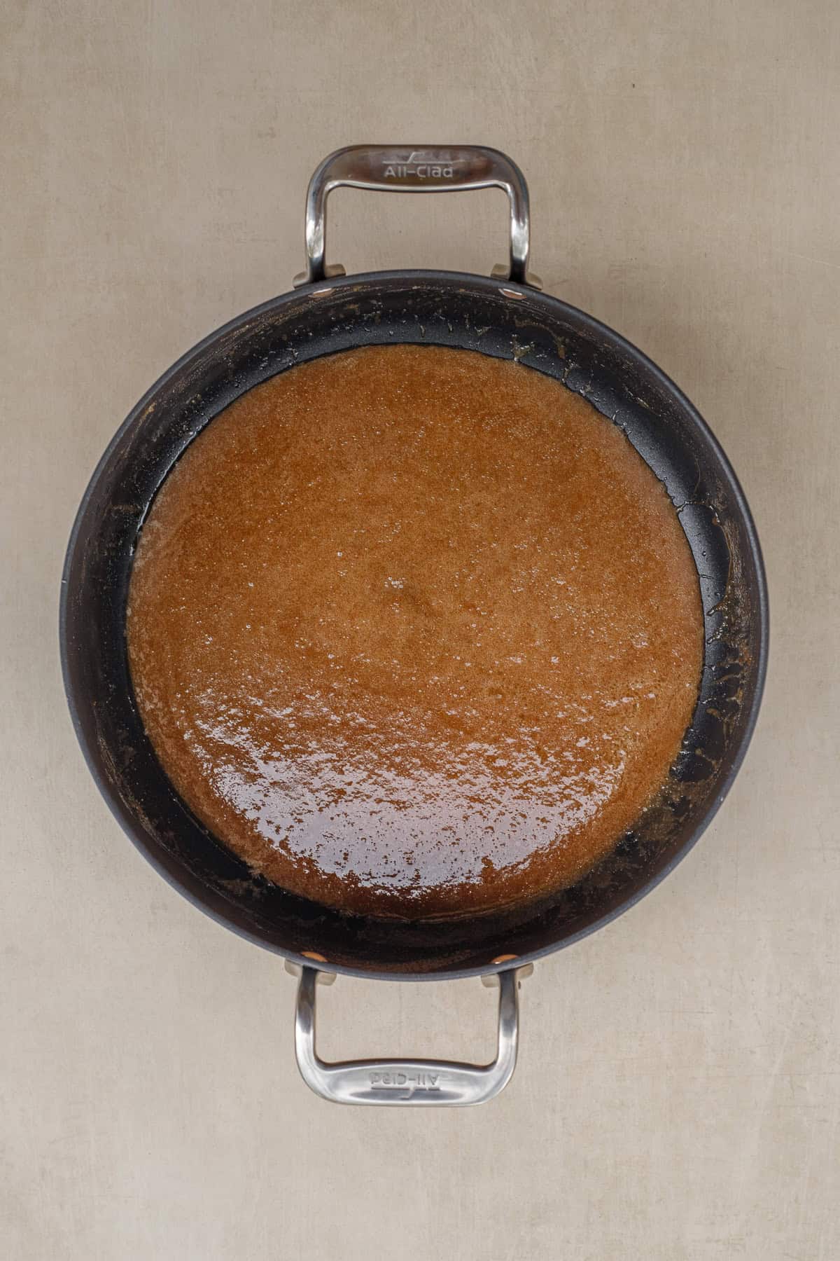 This homemade dutch apple pie is topped with a buttery streusel. A pan with the apple pie filling sauce.