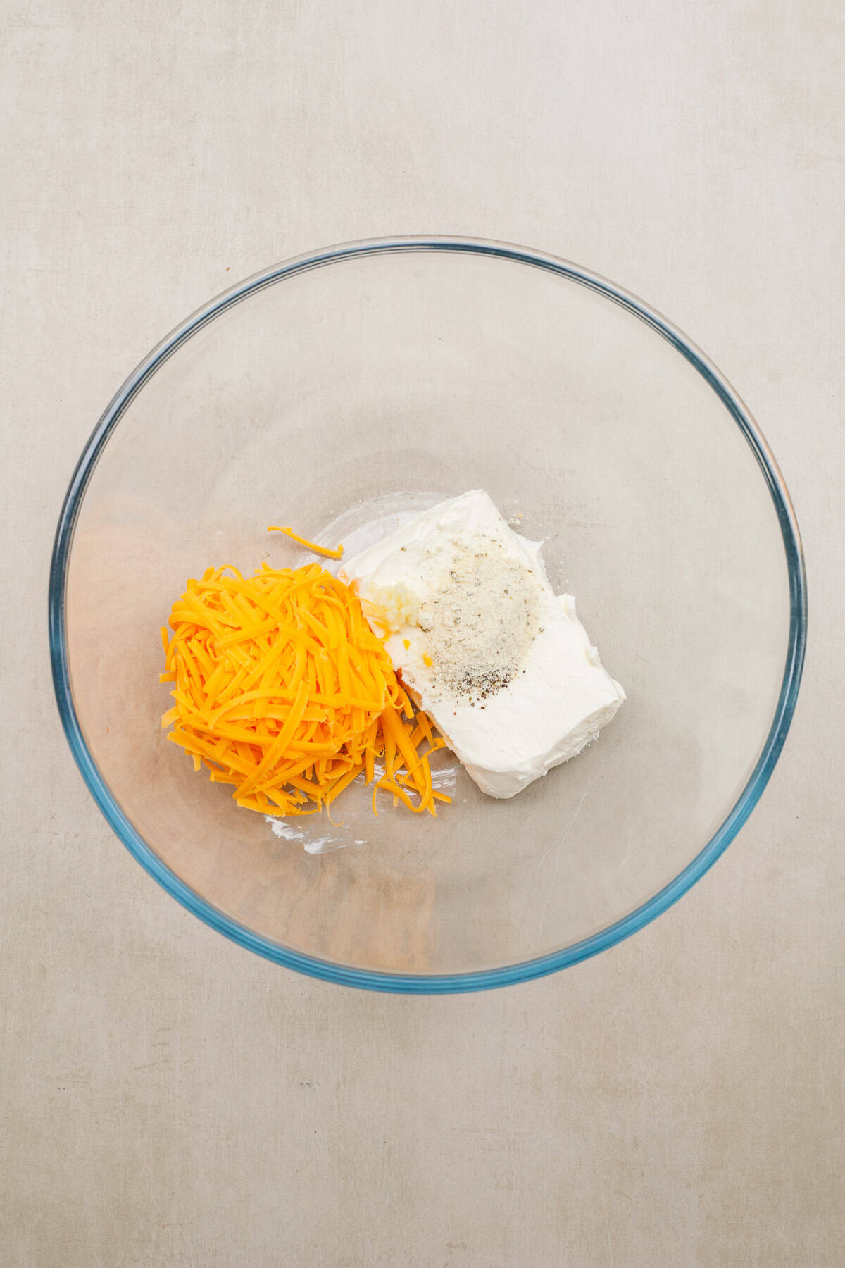 This recipe for bacon wrapped jalapenos makes a simple and delicious appetizer that you won't be able to get enough of. A bowl of the cream cheese filling ingredients.