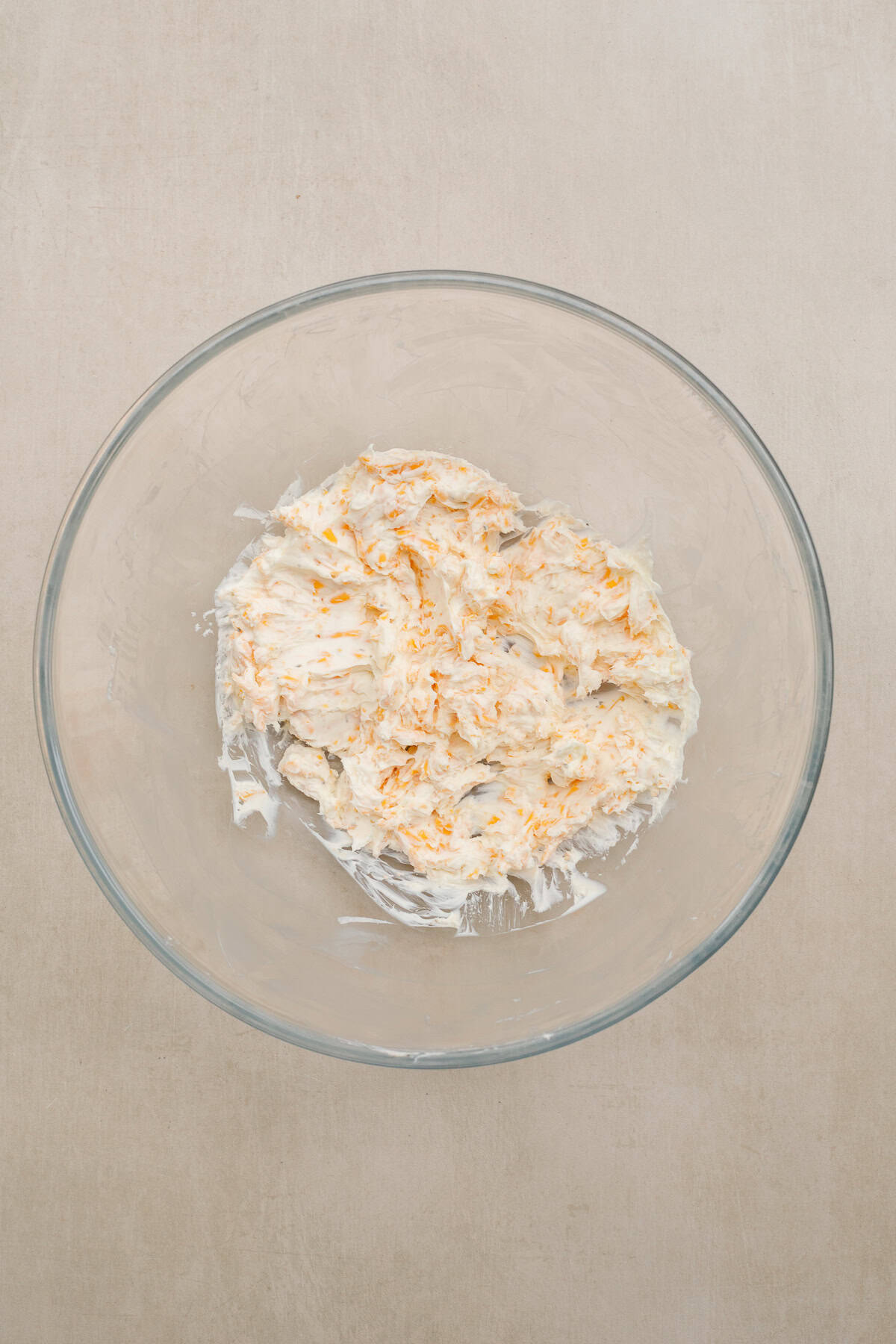 Our easy bacon wrapped jalapeno poppers consist of a rich cream cheese filling, packed in a spicy pepper. Everything is then wrapped tightly in a slice of bacon A bowl of the cream cheese mixture for bacon wrapped jalapenos.