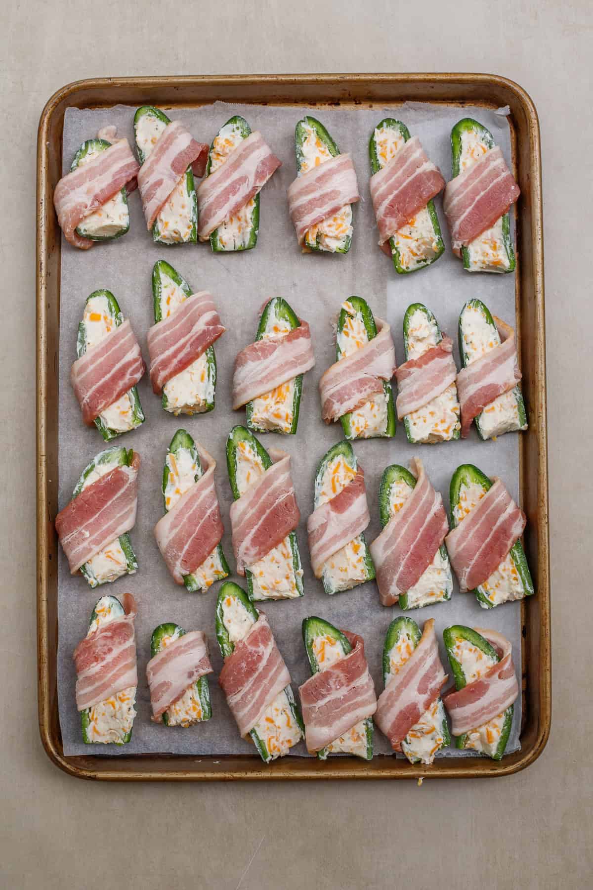 It's not an appetizer table without crispy and cheesy jalapeno poppers. A baking sheet with the bacon wrapped jalapeno poppers.