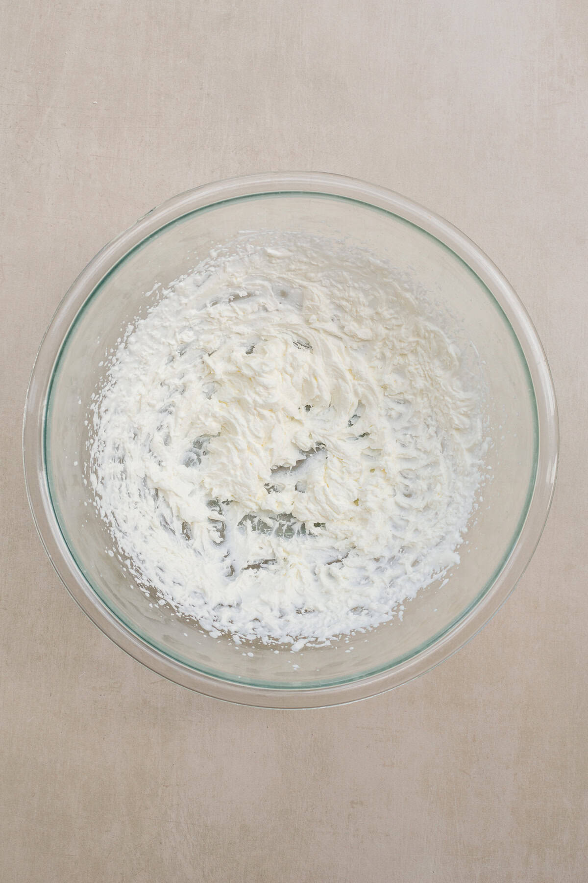 A homemade pistachio buttercream takes these dubai chocolate horns to the next level. A glass bowl with the beaten whipped cream.