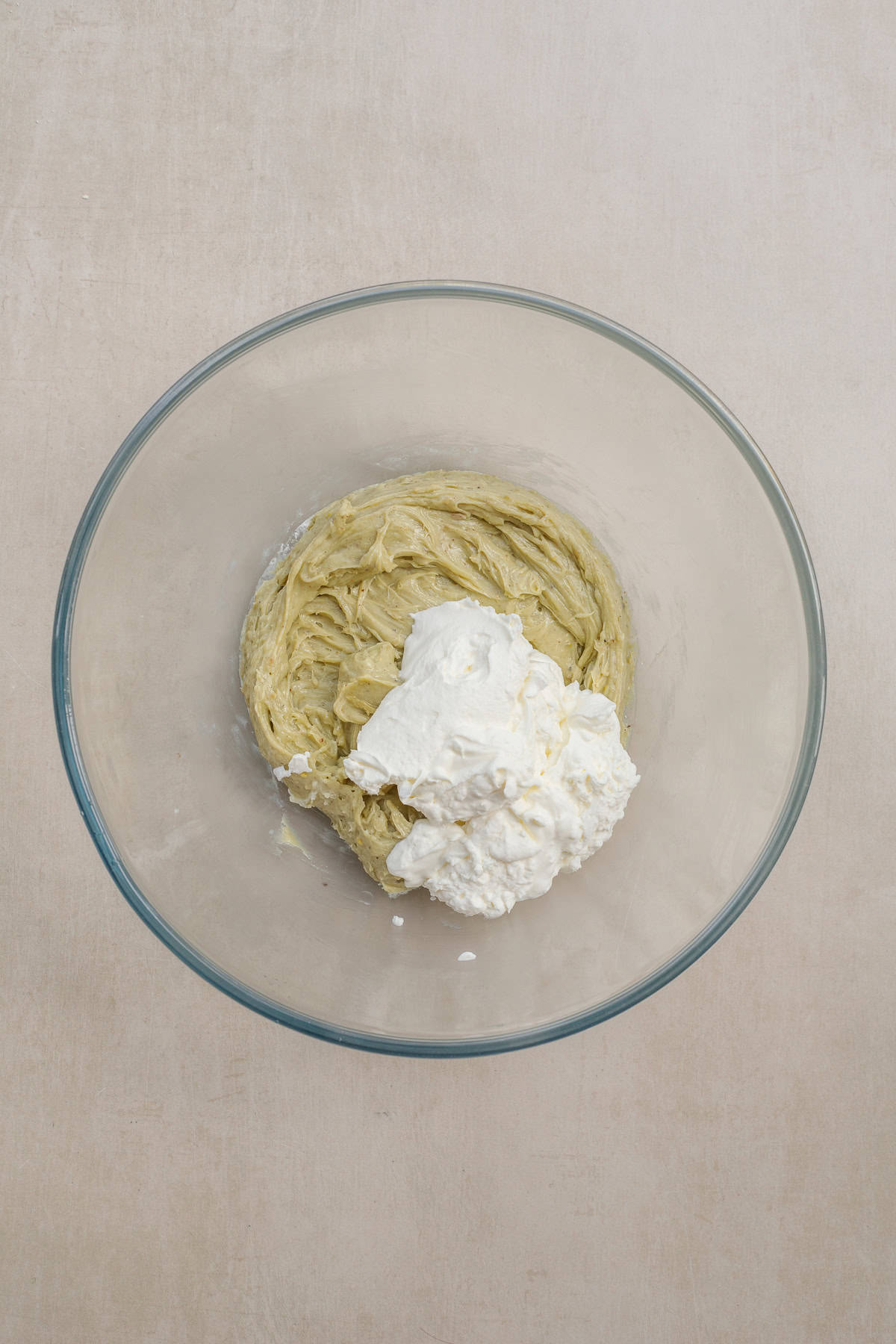 Nothing beats these pistachio dubai chocolate horns. A glass bowl with the pistachio cream cheese and whipped cream.