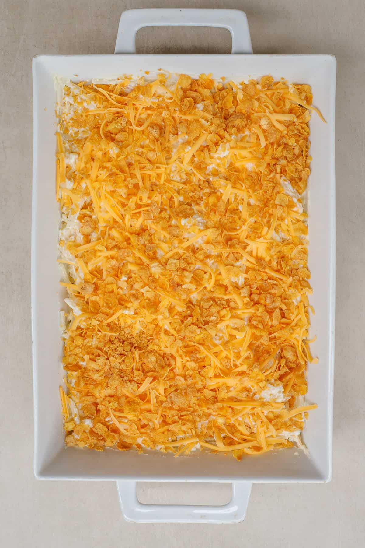 This classic hash brown casserole is an American classic. A dish with the hash brown casserole, topped with cornflakes and cheese.