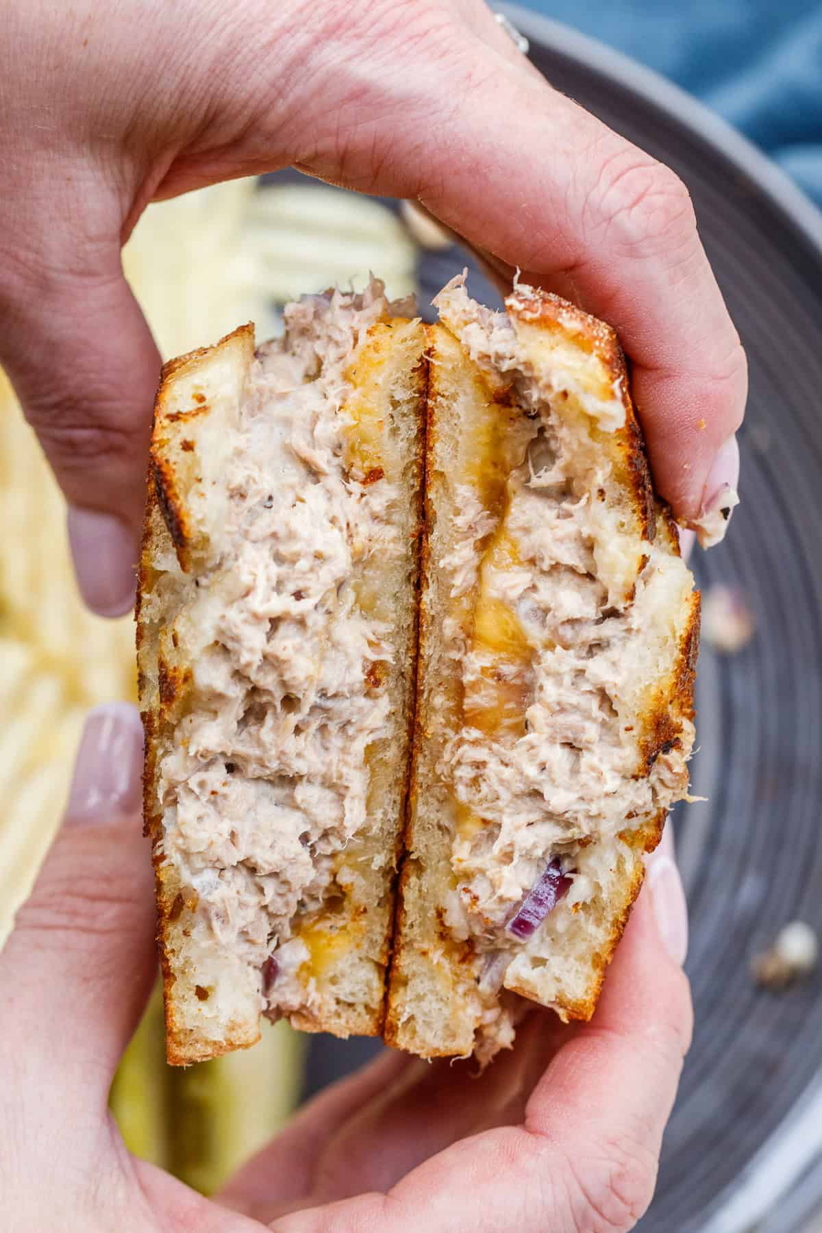 This easy tuna melt sandwich makes the perfect high protein lunch. Sliced tuna melt sandwich showing the layers of tuna and melted cheese.