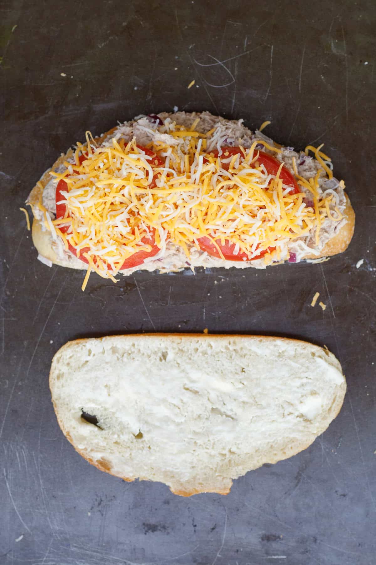 This cheesy tuna melt recipe is the perfect sandwich to make in less than 15 minutes. The slices of bread with a layer of mayo, tuna, tomatoes, and cheese.