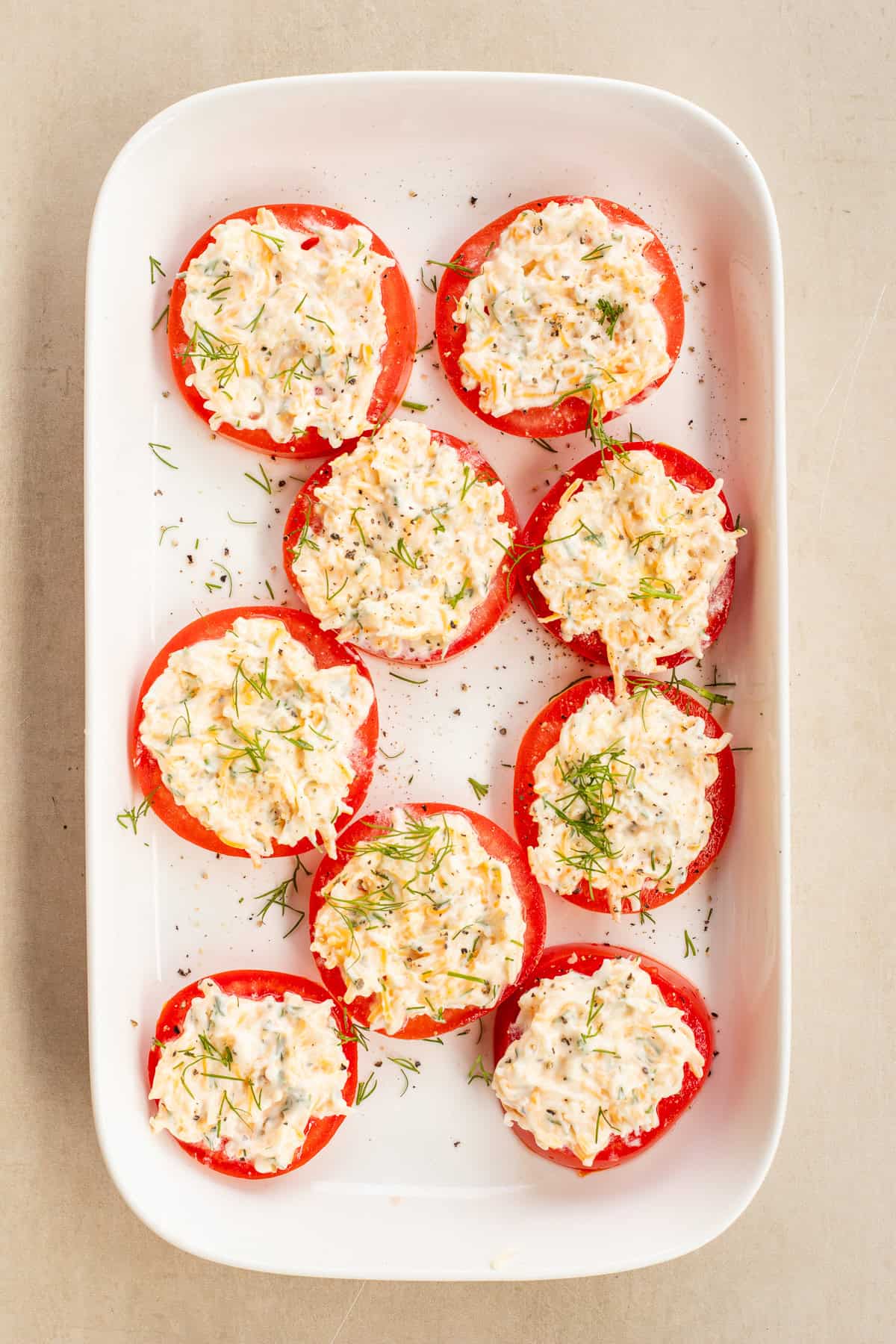 This easy and delicious tomato and cheese appetizer makes the perfect party appetizer. All of the tomato slices topped with the cheesy garlic mixture.
