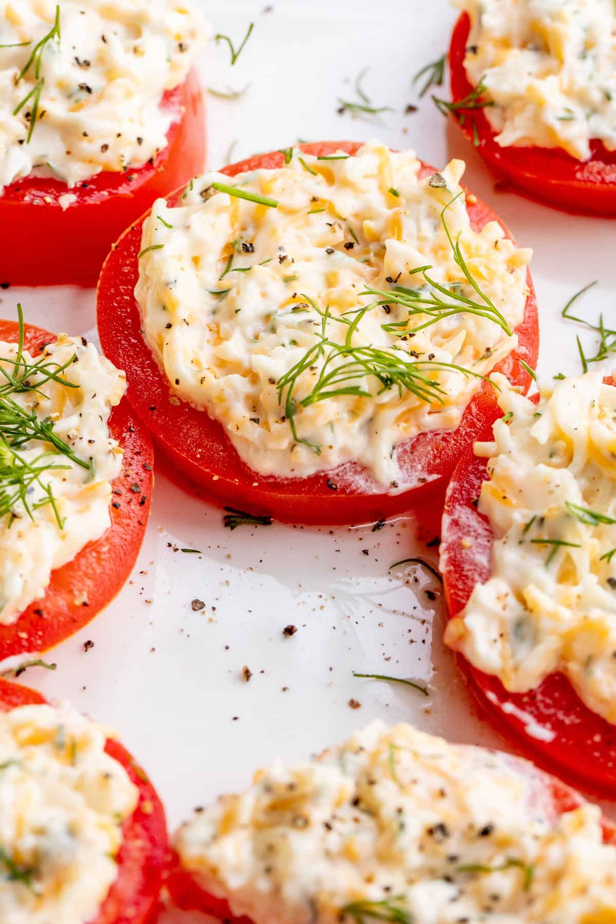 This easy tomato with cheese appetizer is the perfect easy and delicious starter. Thick tomato slices topped with a creamy garlic and cheese spread.