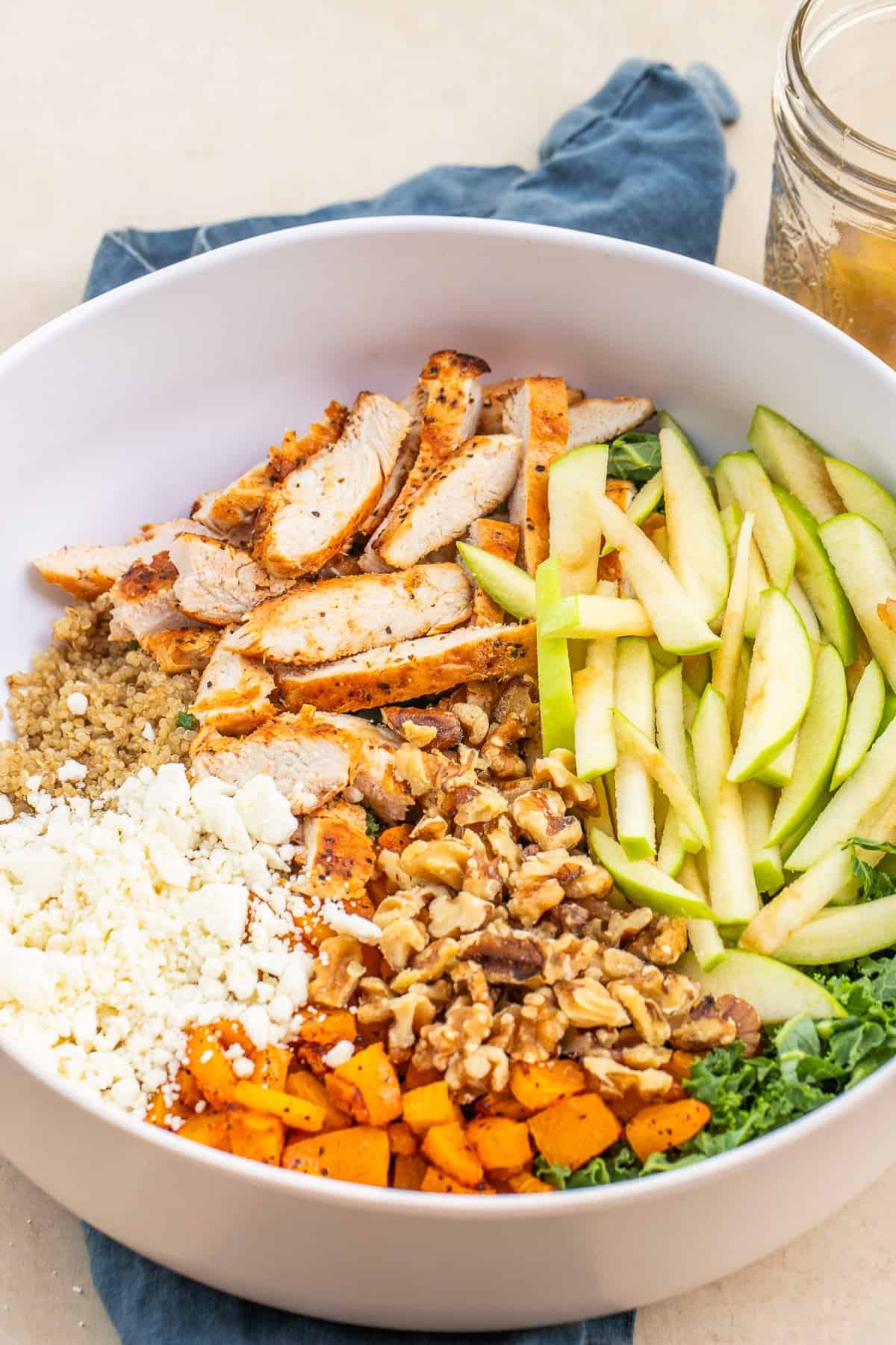This loaded chicken harvest bowl makes a delicious protein packed recipe. A bowl with winter harvest toppings and ingredients.