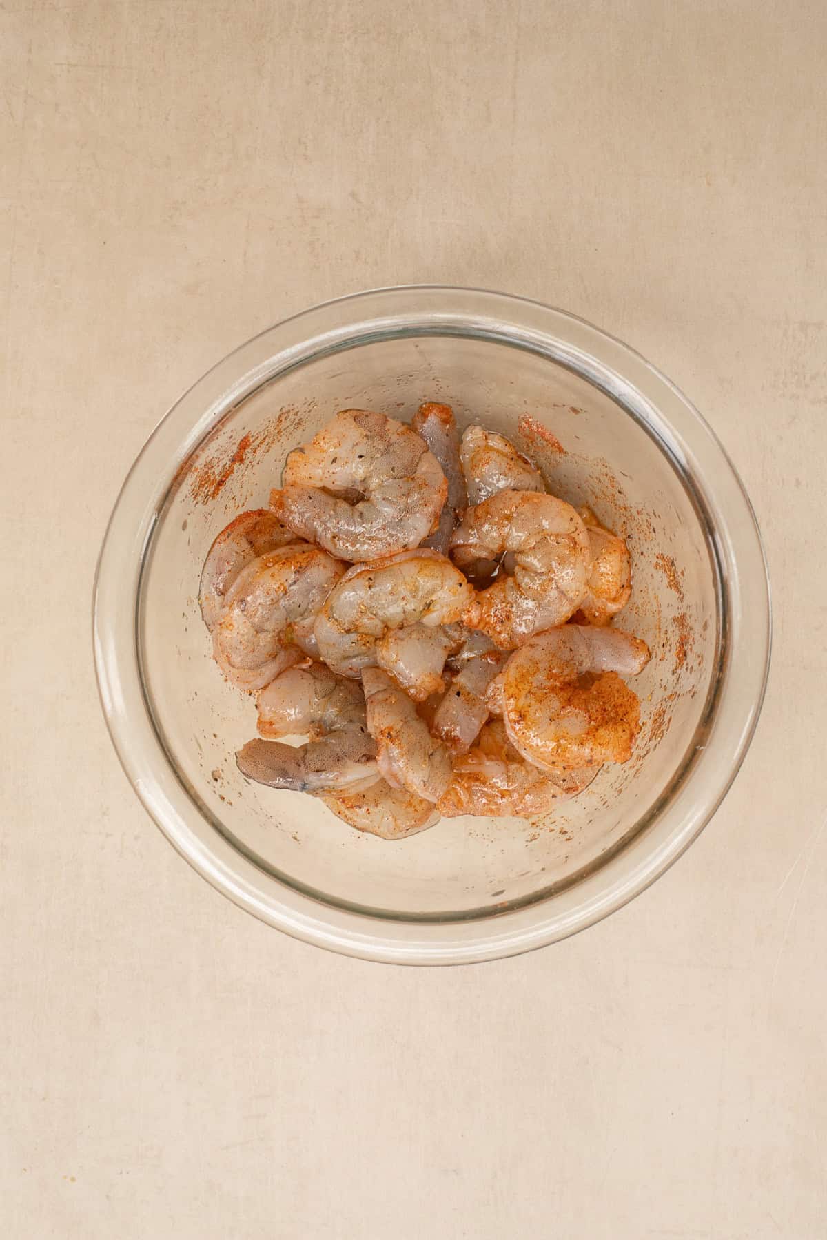 Easy and delicious shrimp and avocado canapes make the perfect bite-sized appetizer. A glass bowl of seasoned shrimp.