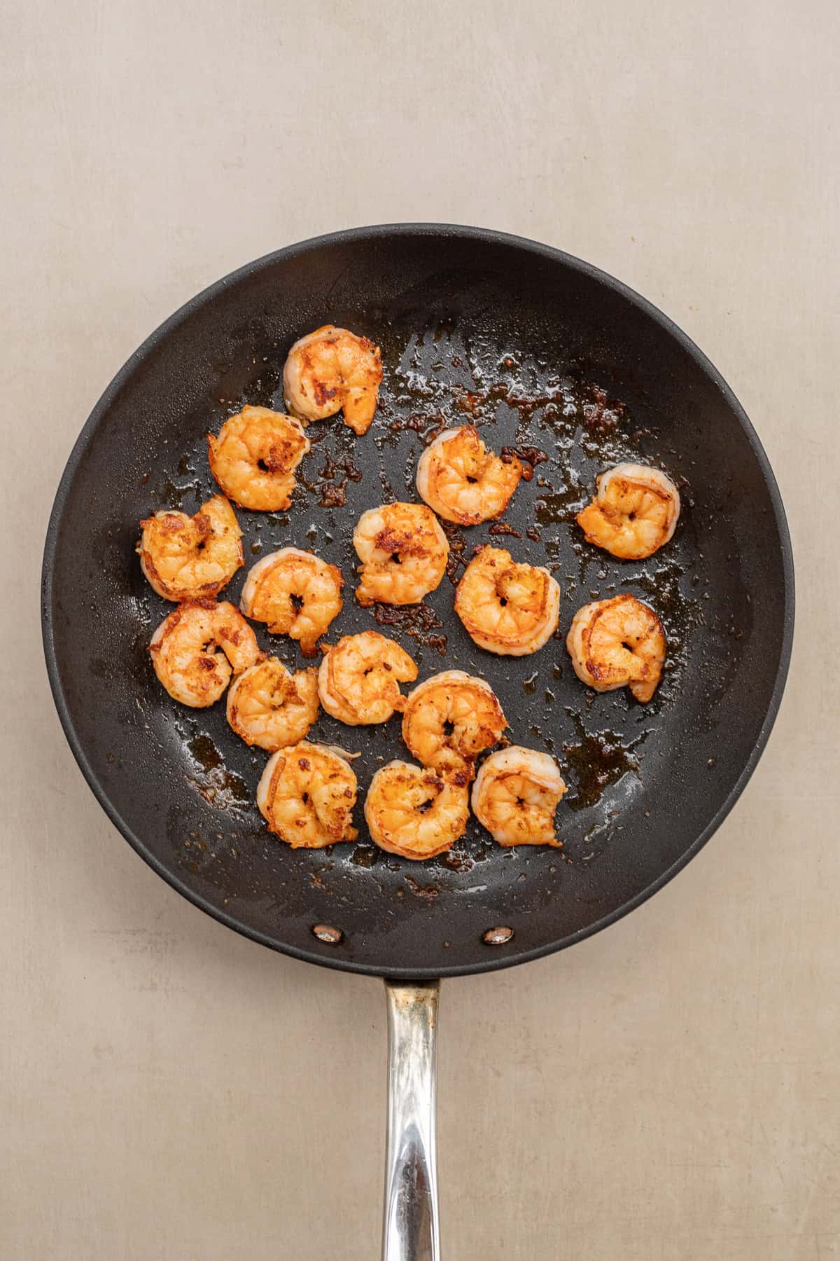 SImple shrimp and avocado canapes make the perfect appetizer. A pan with the cooking shrimp.