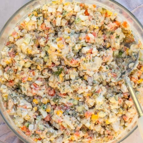 Creamy chicken olivye in a salad bowl.