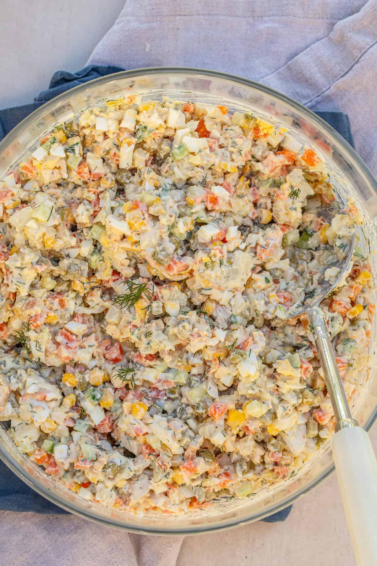 A russian olivye recipe makes a creamy and crunchy salad, loaded with flavor. A large salad bowl of chicken olivye.