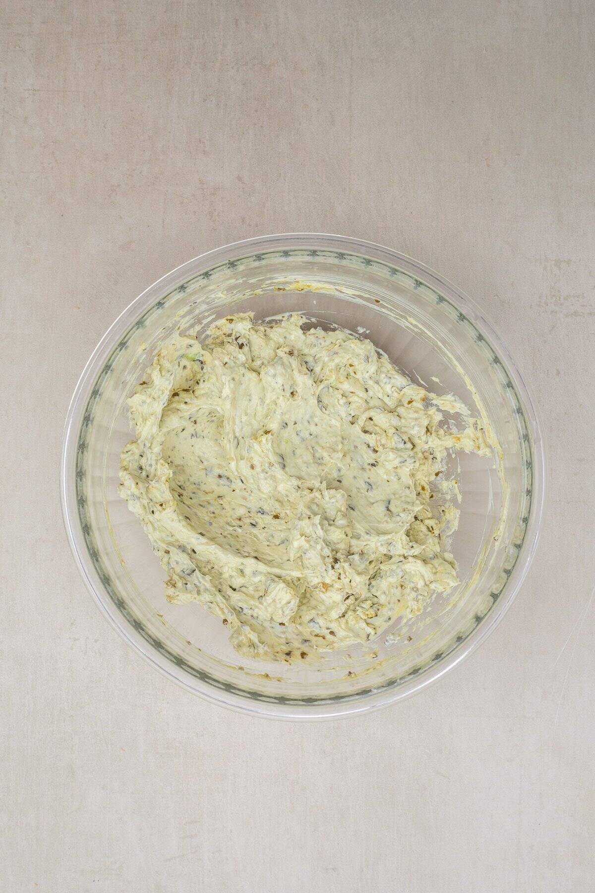 Homemade pesto and tomato canapes are a crowd pleasing appetizer. A glass bowl with the pesto spread.