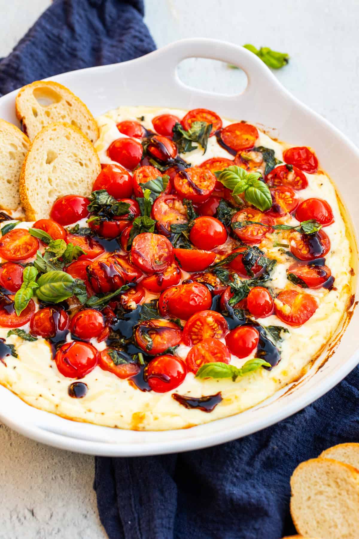 A serving bowl with the baked ricotta tomato dip. 