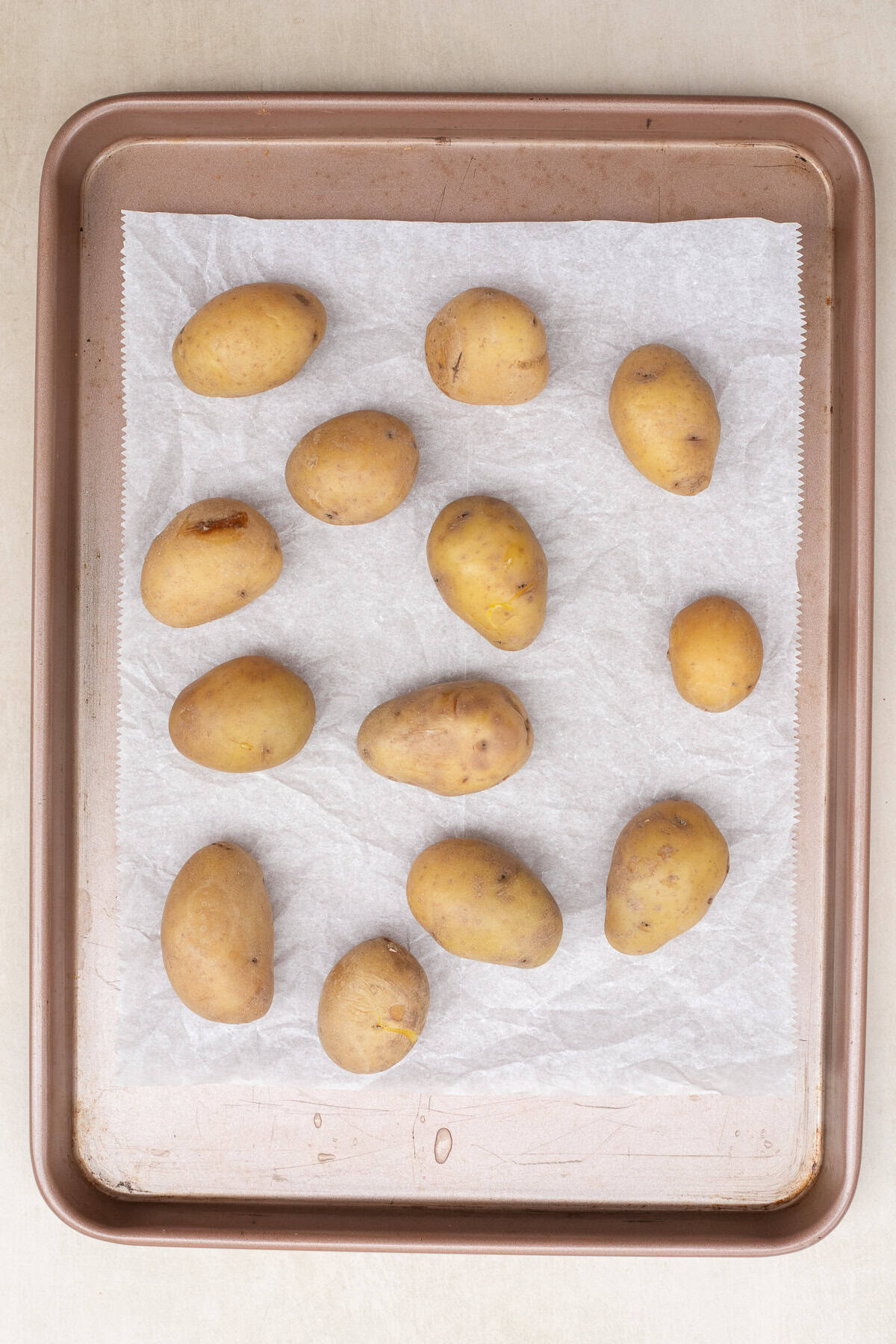 Crispy Smashed Potatoes (Easy Oven Recipe) A pan with the arranged potatoes.