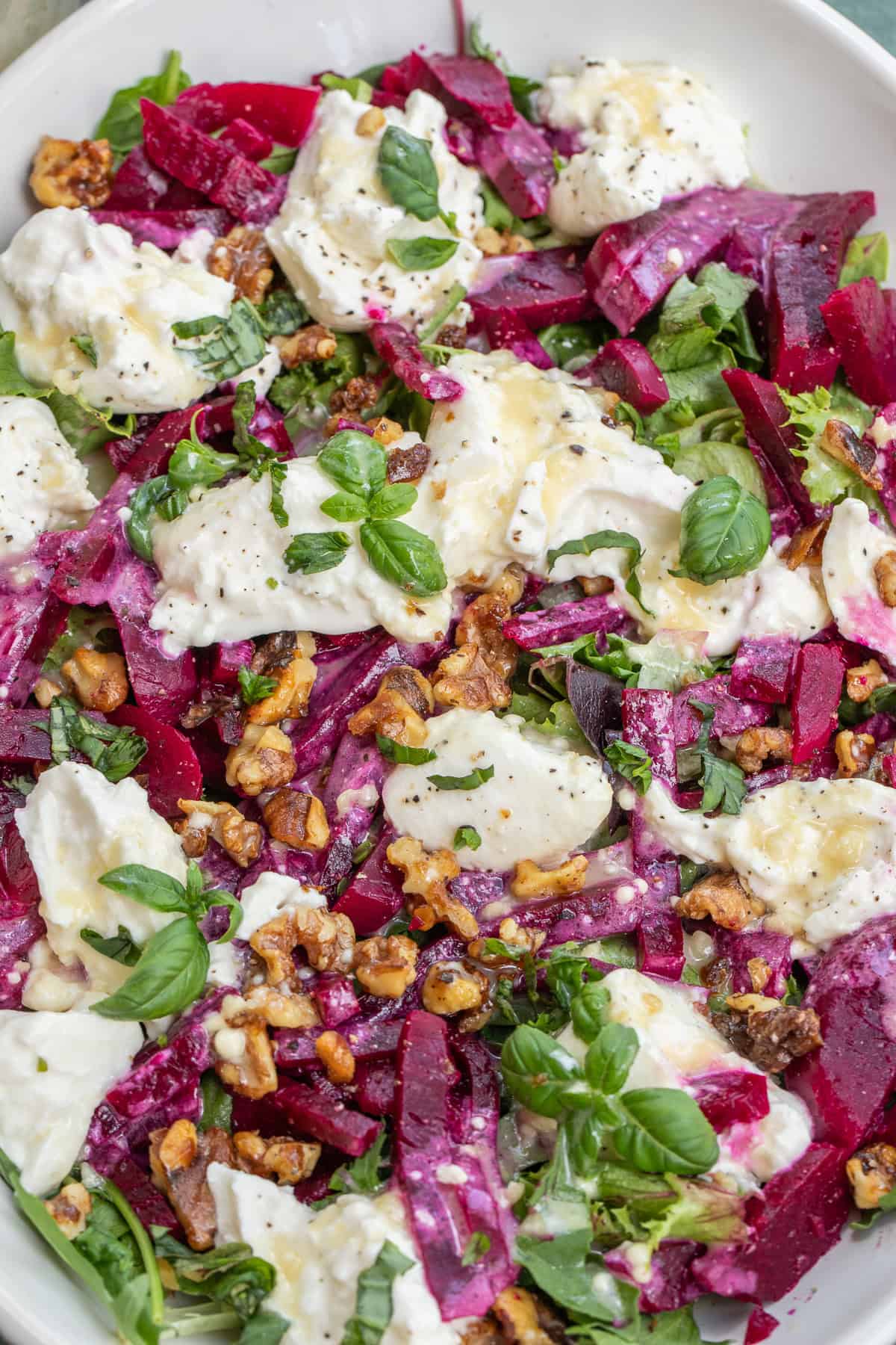 Classic Beet Salad Recipe with Simple Ingredients The beet burrata salad topped with fresh basil.