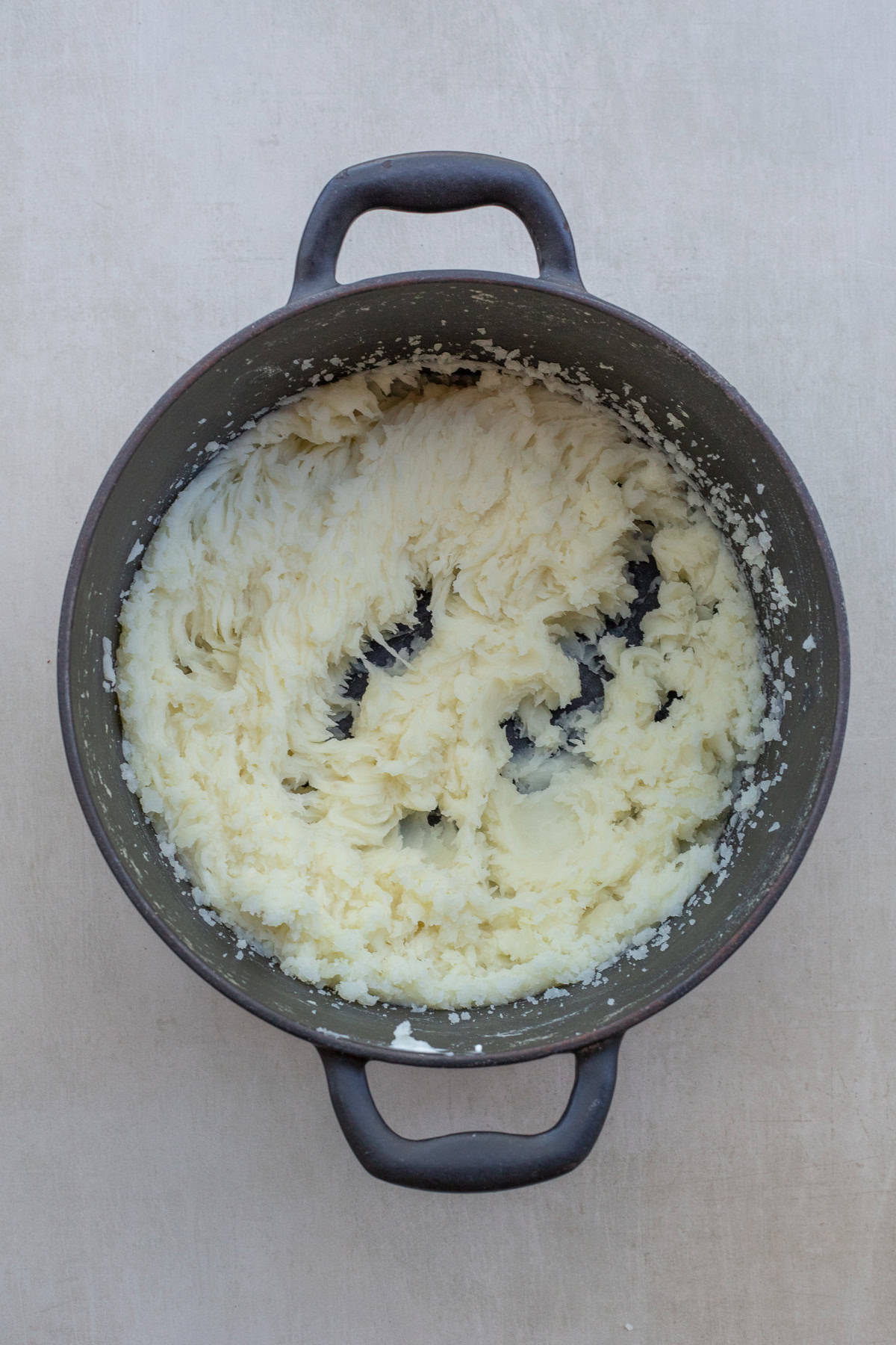 Buttery and creamy mashed potatoes are so easy to make and the result is a restaurant-style side dish. A pot with the mashed potatoes.