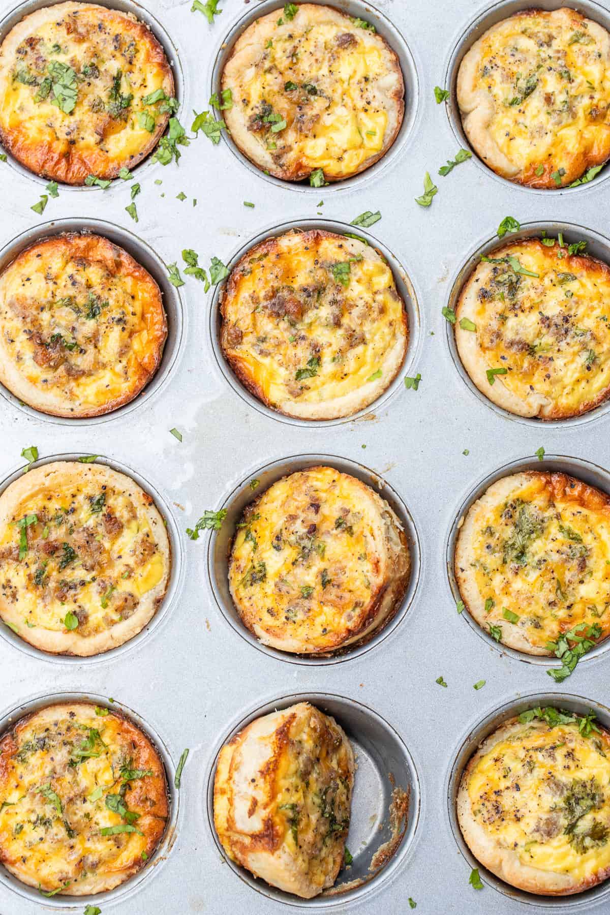 These mini quiches are made with a pie crust from scratch, loaded with a silky egg filling. Mini quiches in a muffin pan.
