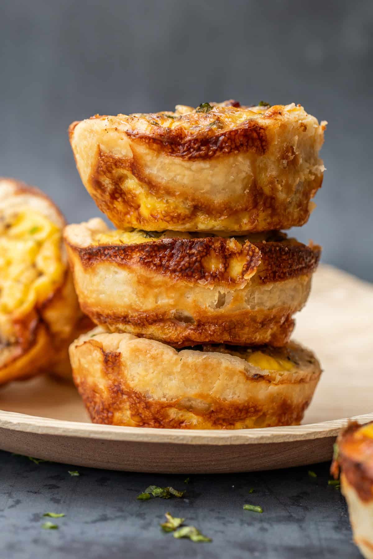 An easy mini quiche recipe makes a simple breakfast that packs all the flavor. Stacked mini quiches with a pie crust base.