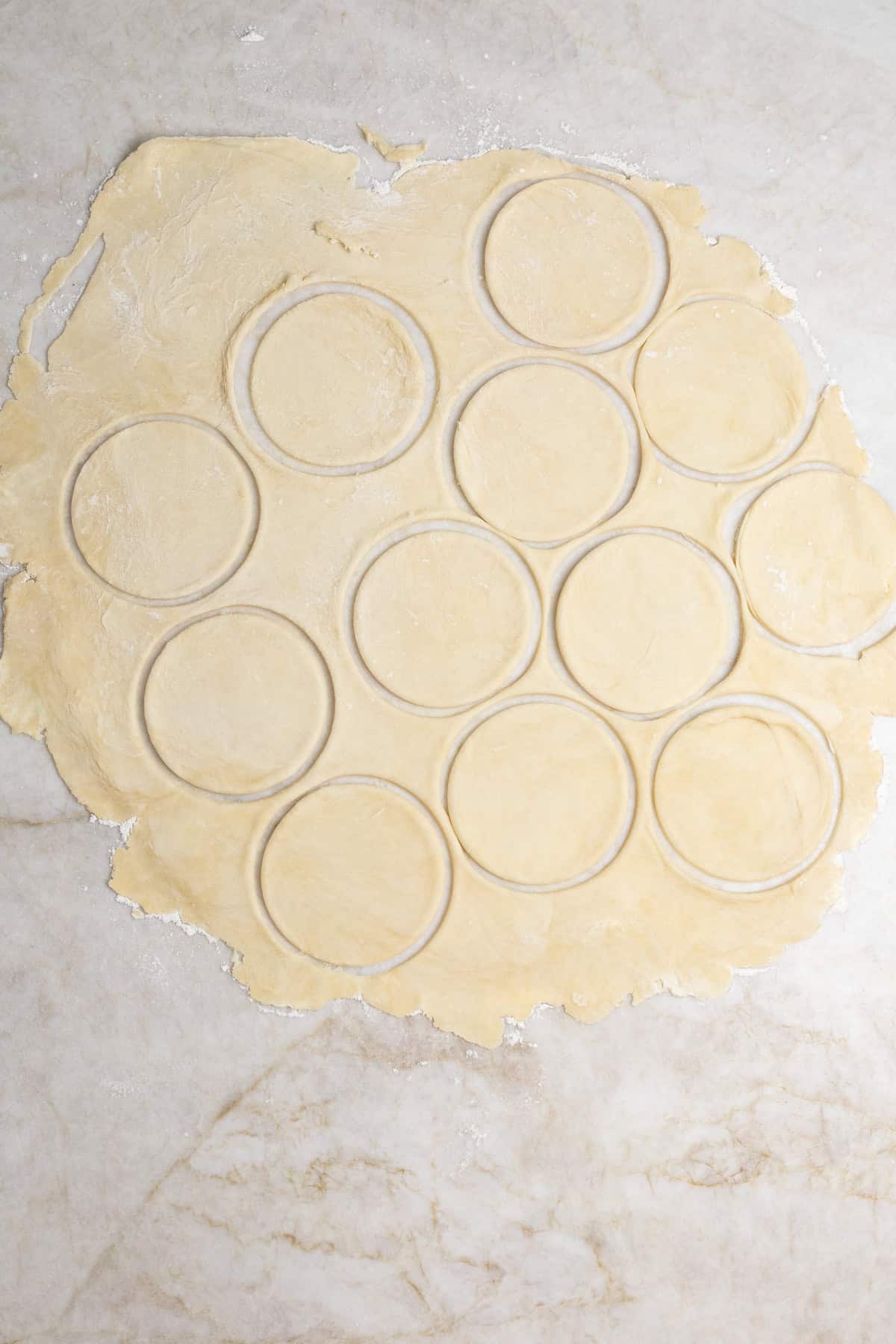 Make-Ahead Mini Quiche Recipe (Freezer Friendly Recipe) A rolled out pie crust with pressed out circles.