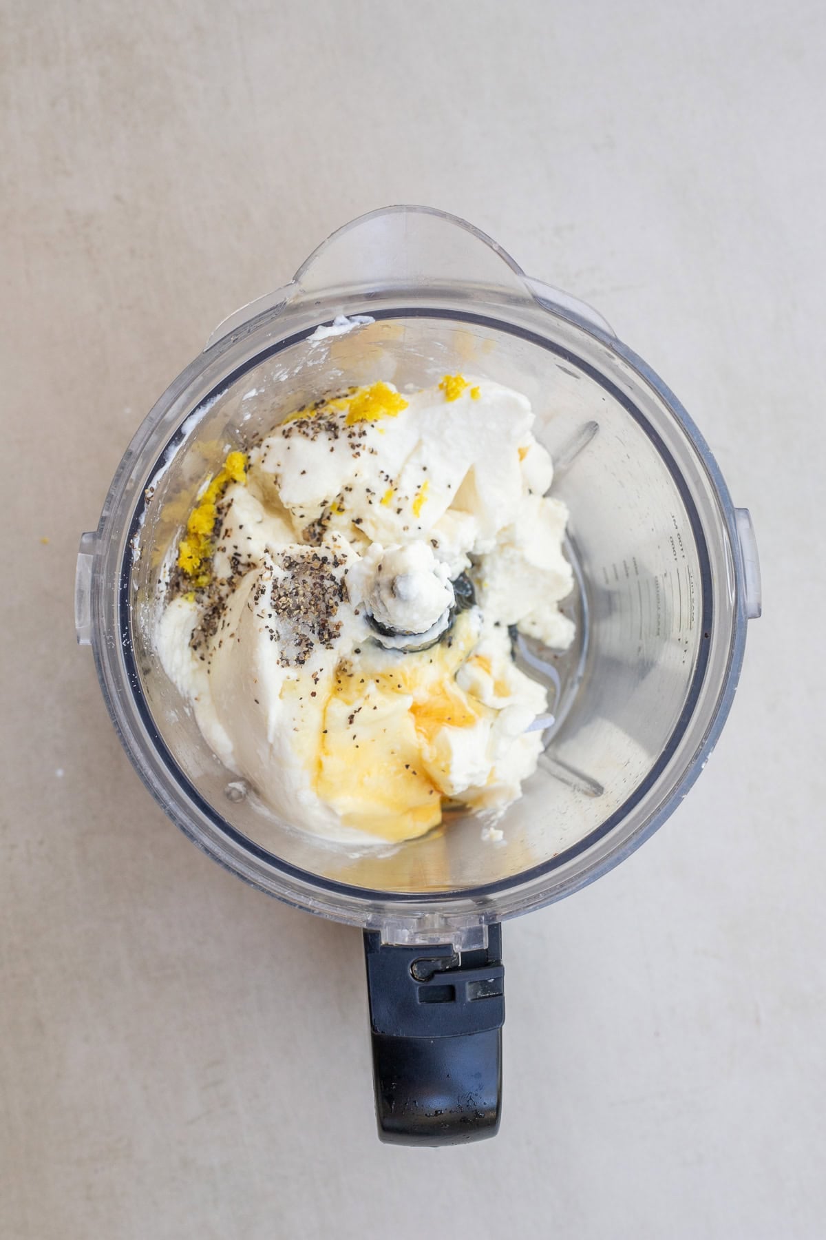 Whipped Ricotta Recipe perfect to serve with bread or crostini. A food processor with all of the whipped ricotta ingredients.