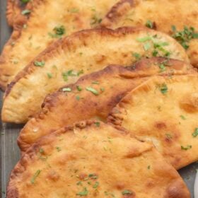Chicken chebureki fried to golden brown.