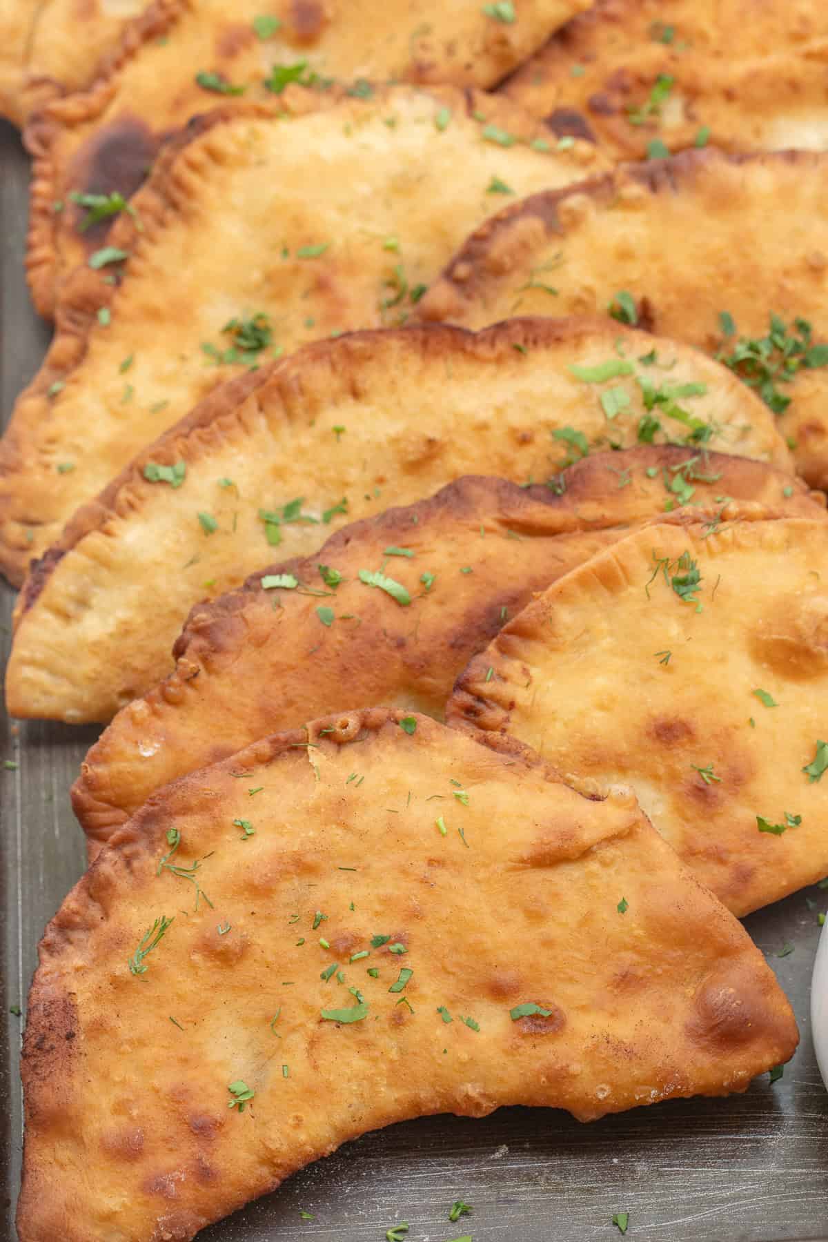 Classic chicken chebureki recipe - the perfect easy entree. Chicken chebureki fried to golden brown.