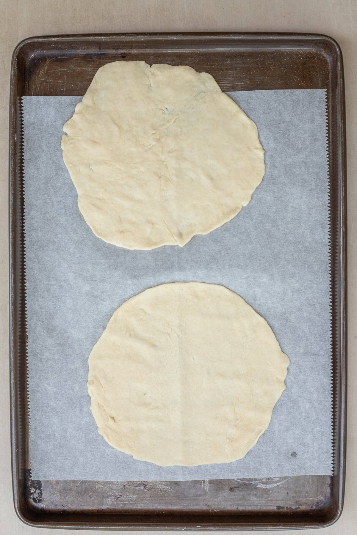 This homemade chicken chebureki recipe makes the perfect dish. The chebureki dough rolled out onto discs.