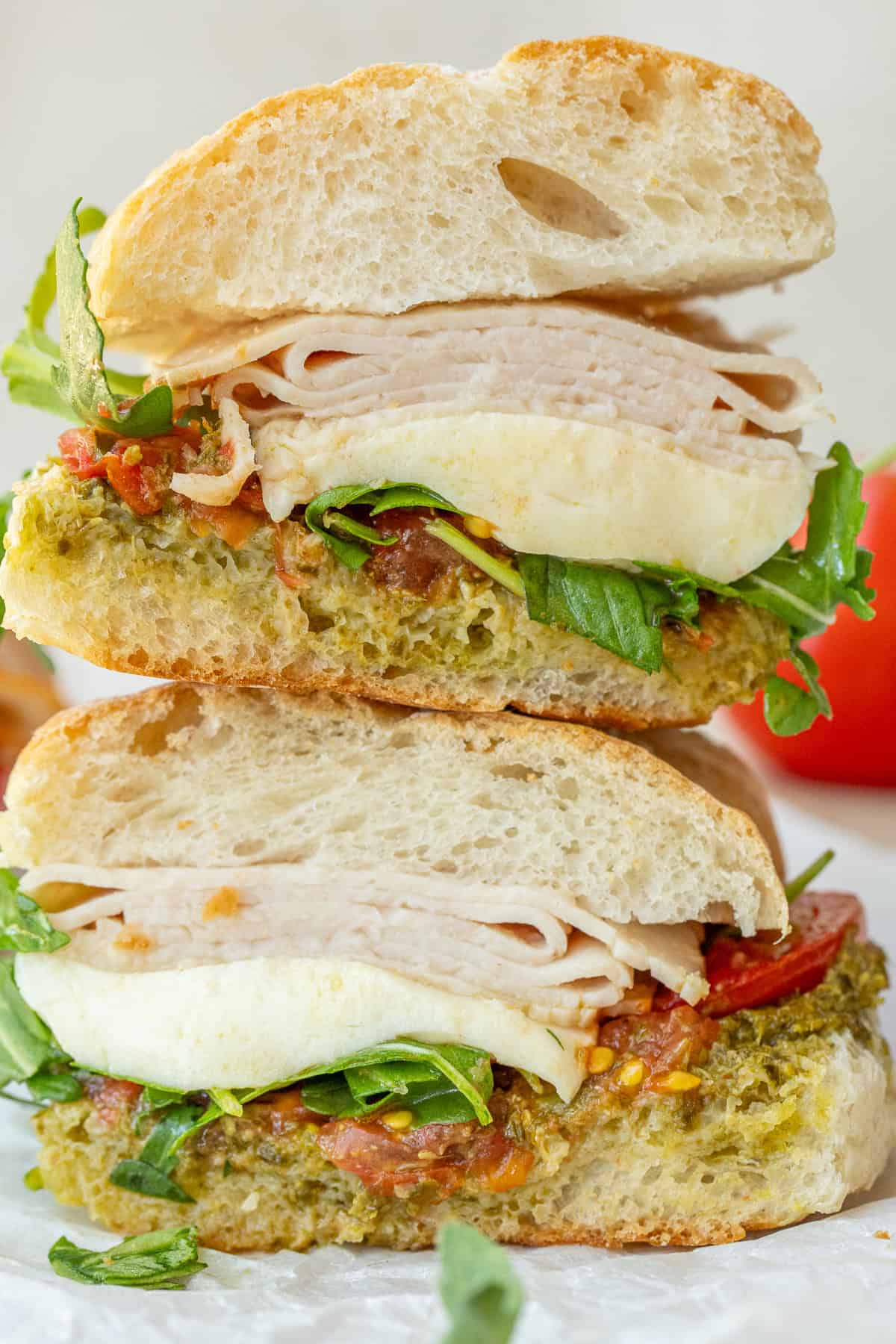 Toasted Chicken Pesto Sandwich Stacked chicken pesto sandwiches.