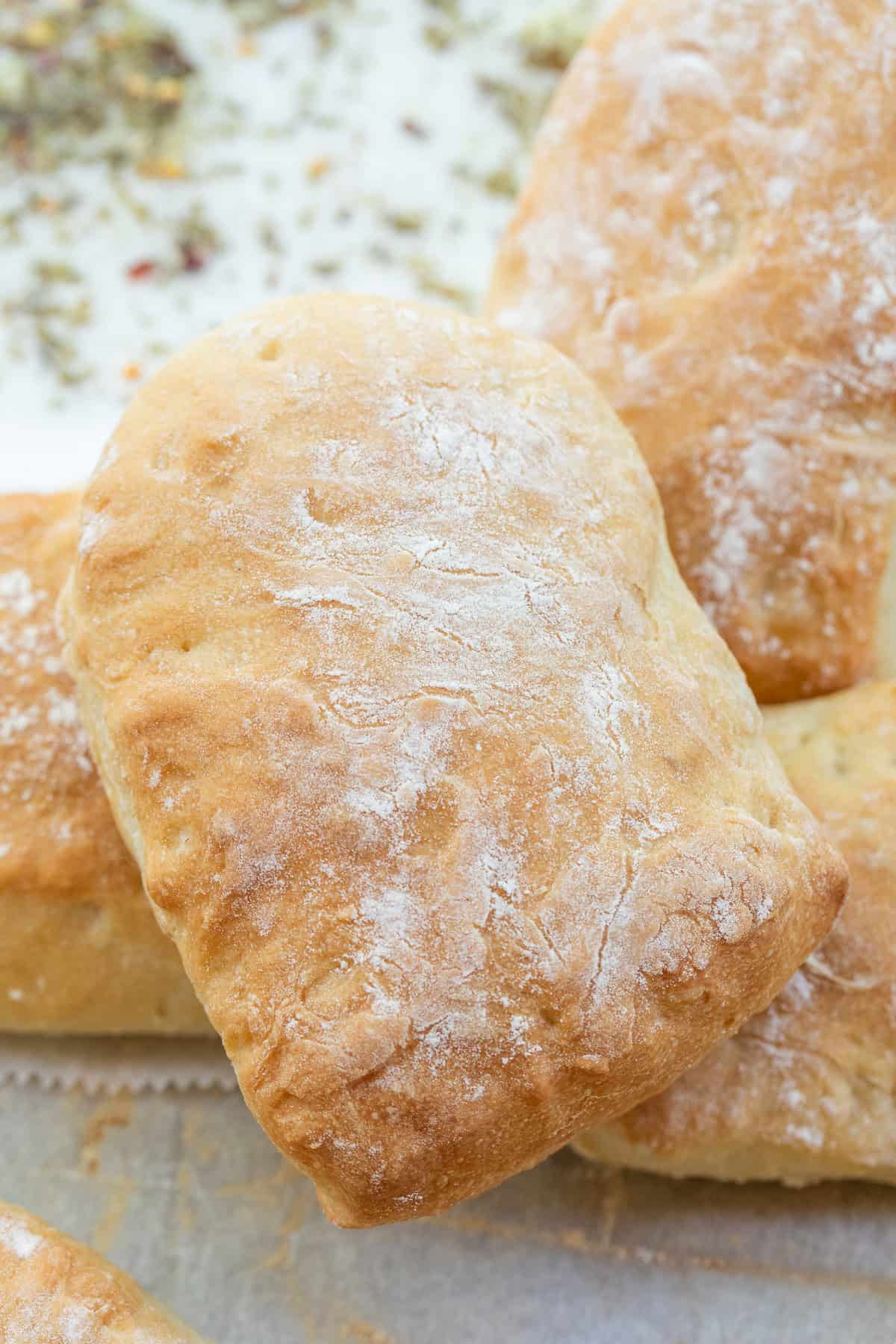 Bakery Style Ciabatta Rolls Recipe Homemade ciabatta rolls stacked on each other.