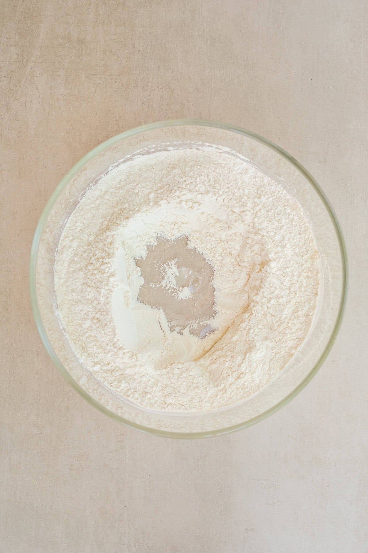 Best Homemade Ciabatta Bread Rolls A glass bowl with the dry ingredients for homemade ciabatta rolls.