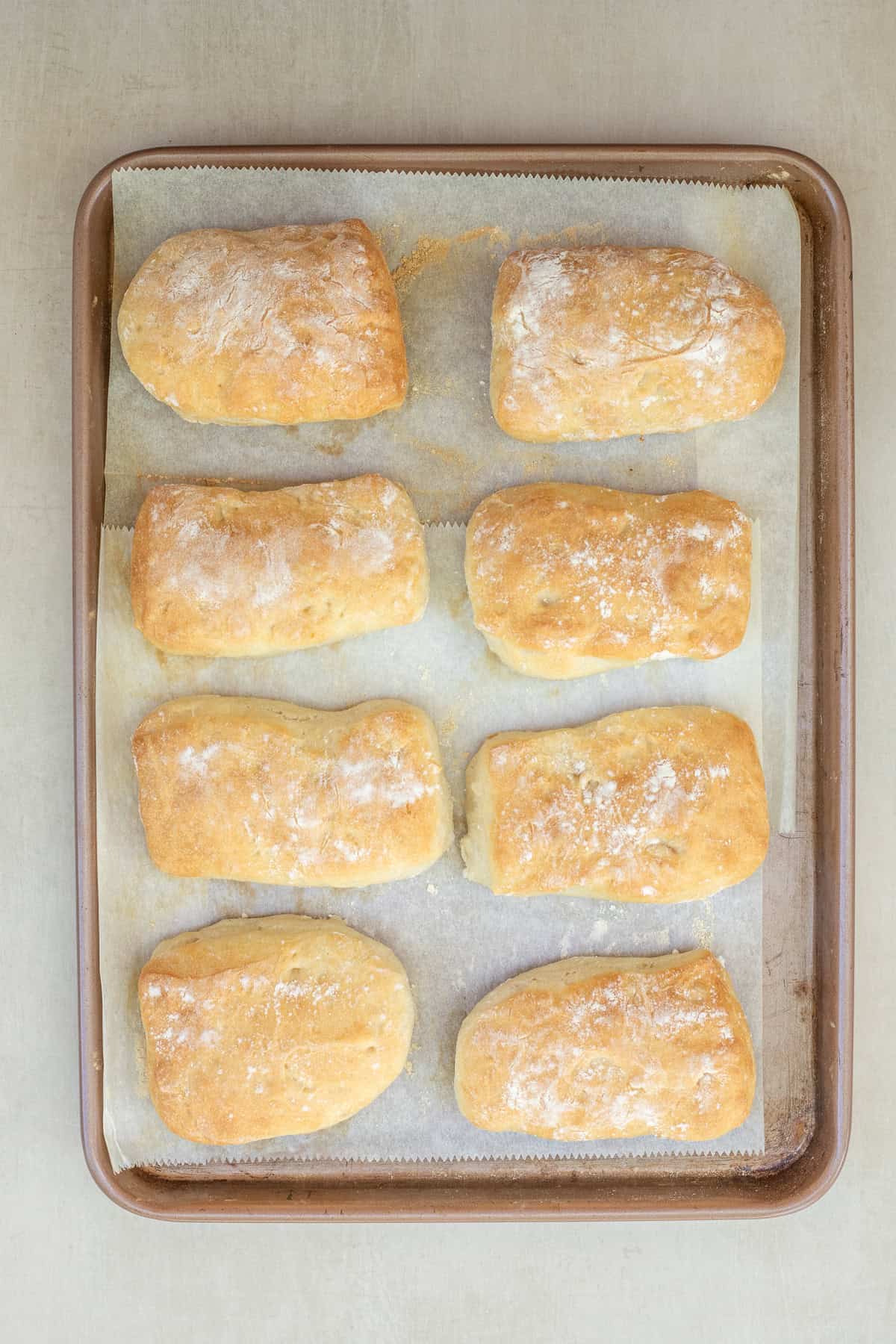 Rustic Ciabatta Rolls Recipe The baked ciabatta rolls on a baking sheet.
