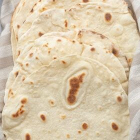 Flour tortillas in a cloth towel.