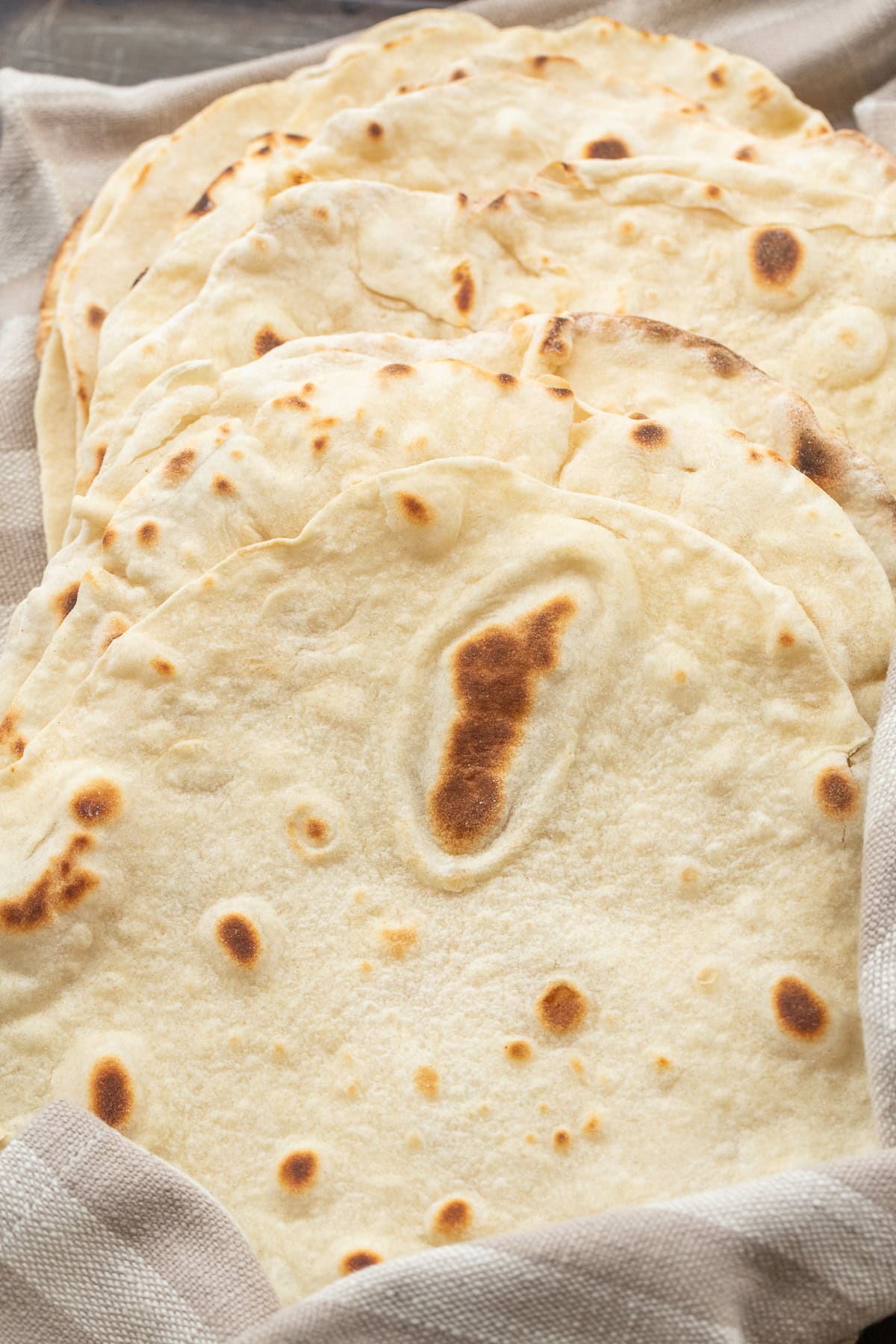 Soft & Fluffy Tortillas Made from Scratch Fluffy tortillas cooked and stacked.