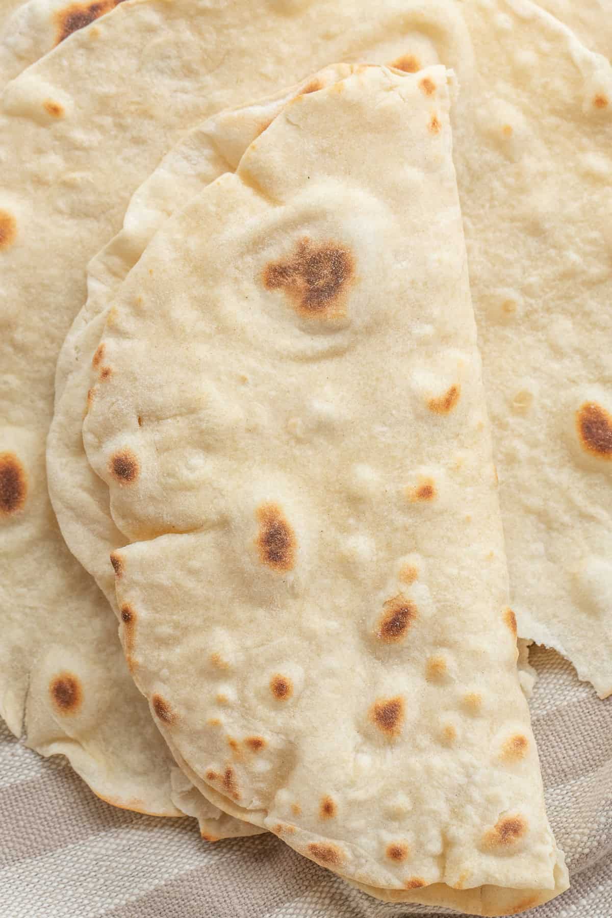 Easy Flour Tortillas Better Than Store-Bought A folded over tortilla cooked.