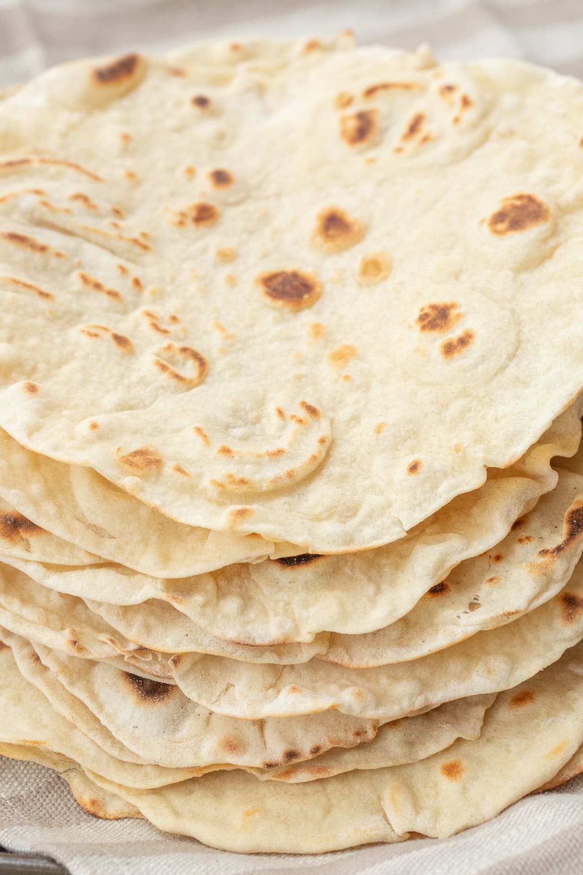 Homemade Flour Tortilla Recipe from Scratch A stack of homemade tortillas.