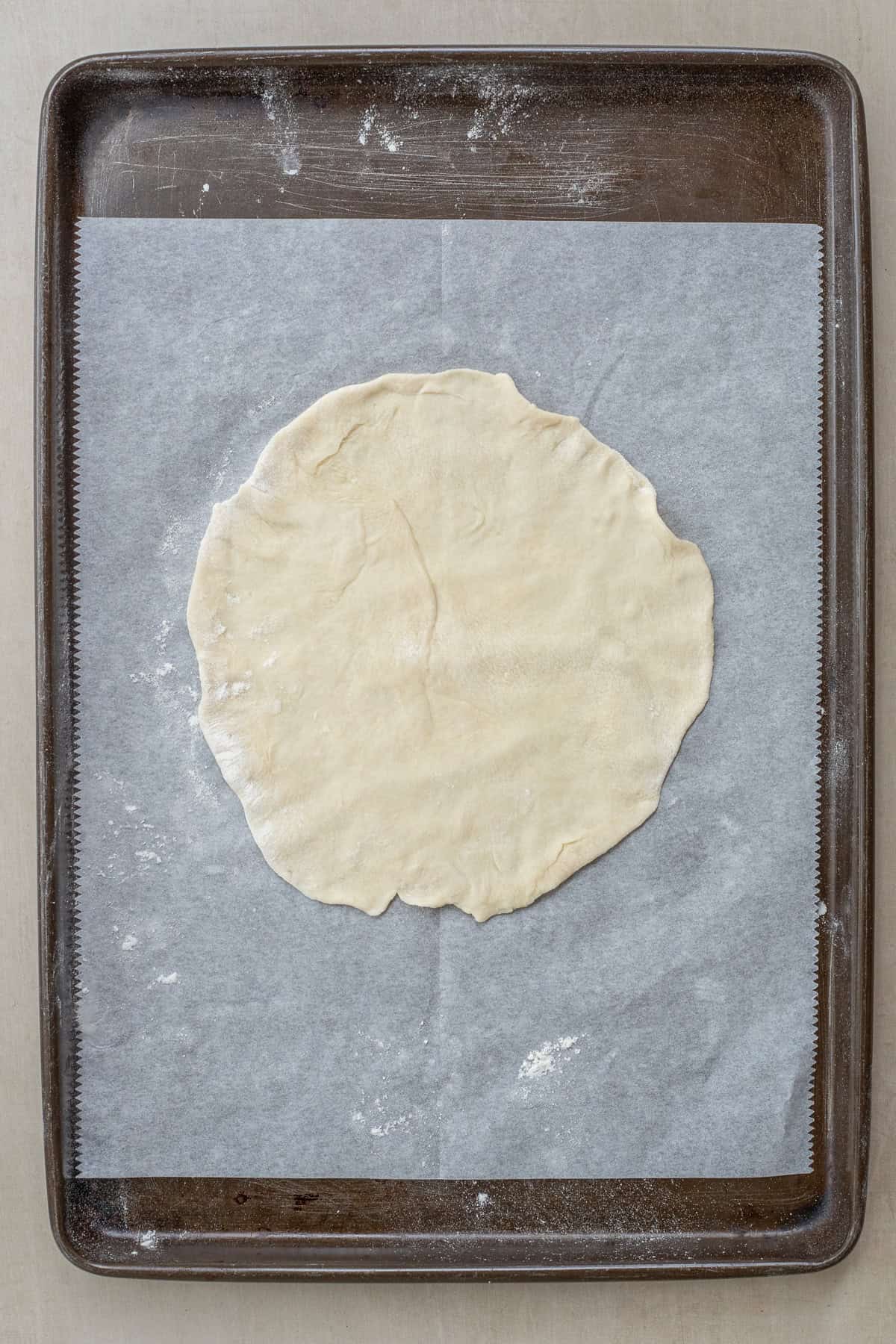Homemade Flour Tortillas for Tacos and Burritos The dough ball rolled out into a thin tortilla.