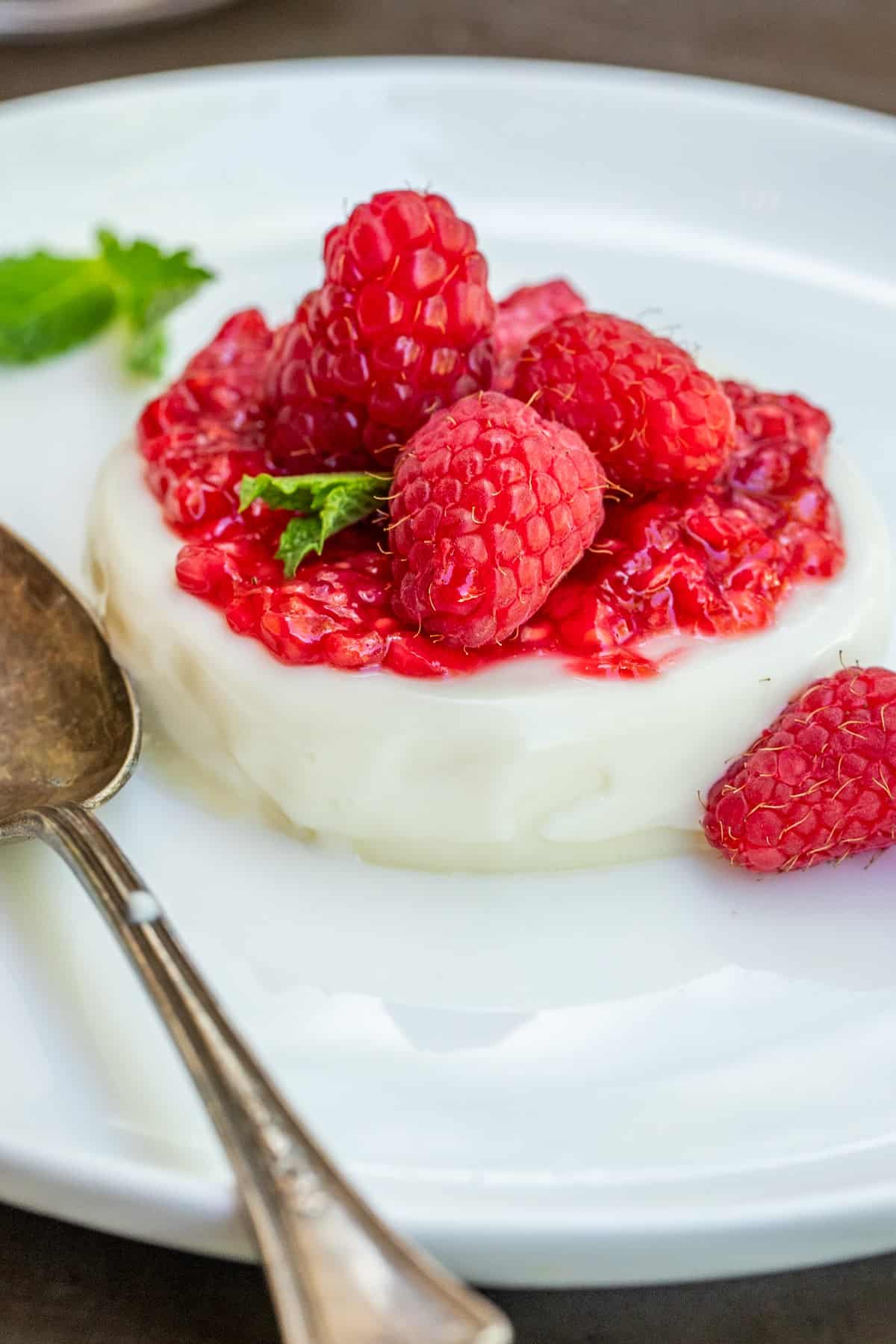 No Bake Panna Cotta Dessert Classic panna cotta topped with raspberry sauce.