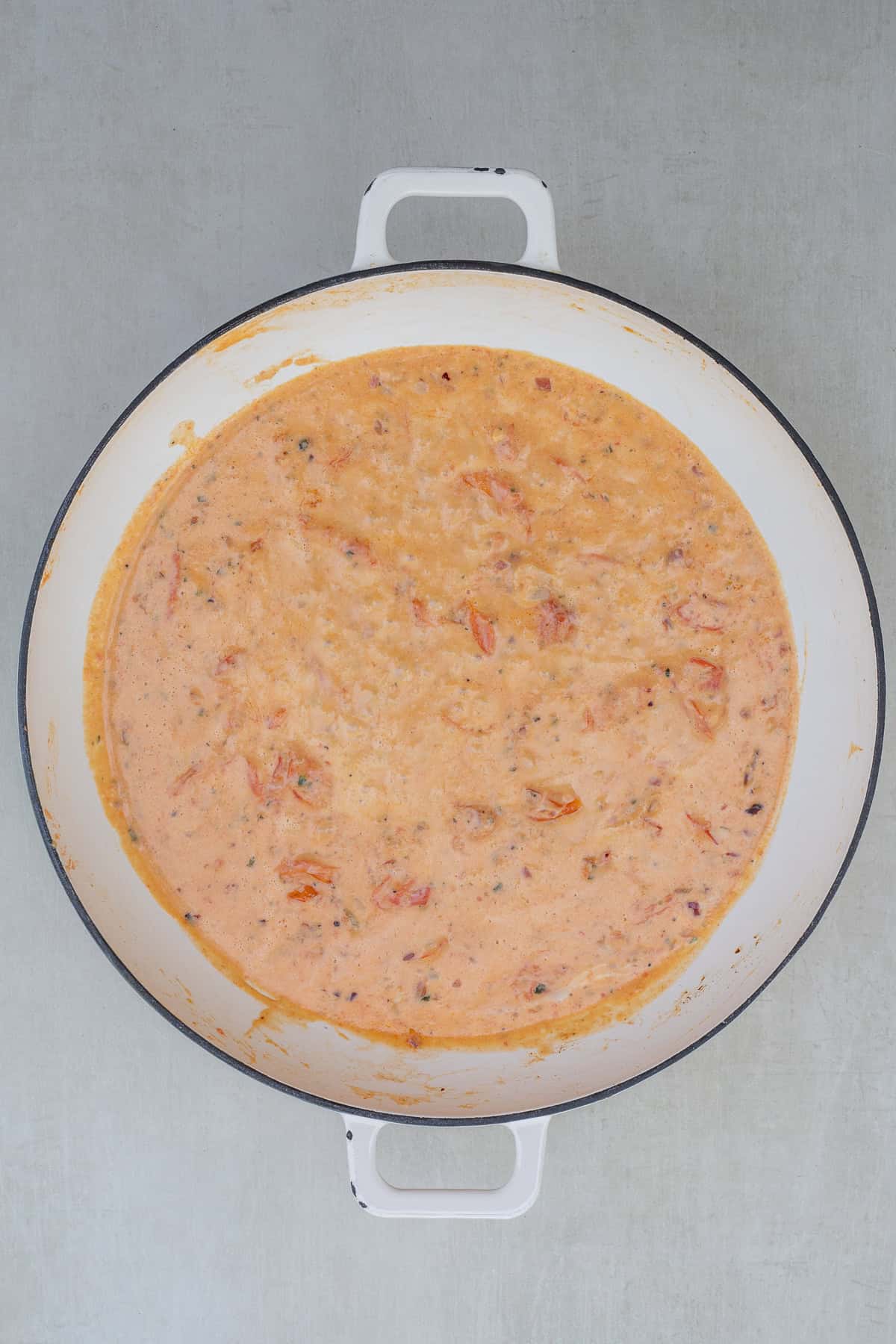 Creamy Boursin Tomato Pasta Recipe with Garlic and Herbs A pot of creamy pasta sauce for tomato boursin pasta.