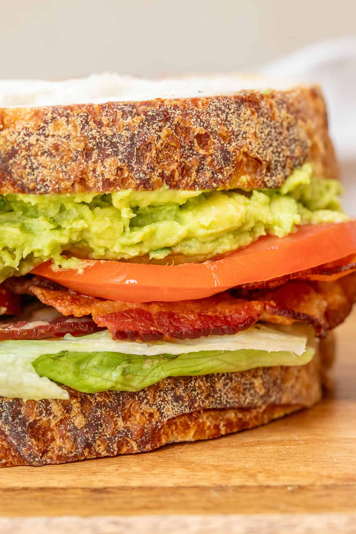 This classic BLT sandwich recipe delivers the perfect combination of savory, fresh, and crispy flavors. Fluffy slices of white bread with creamy avocado and crispy bacon slices.
