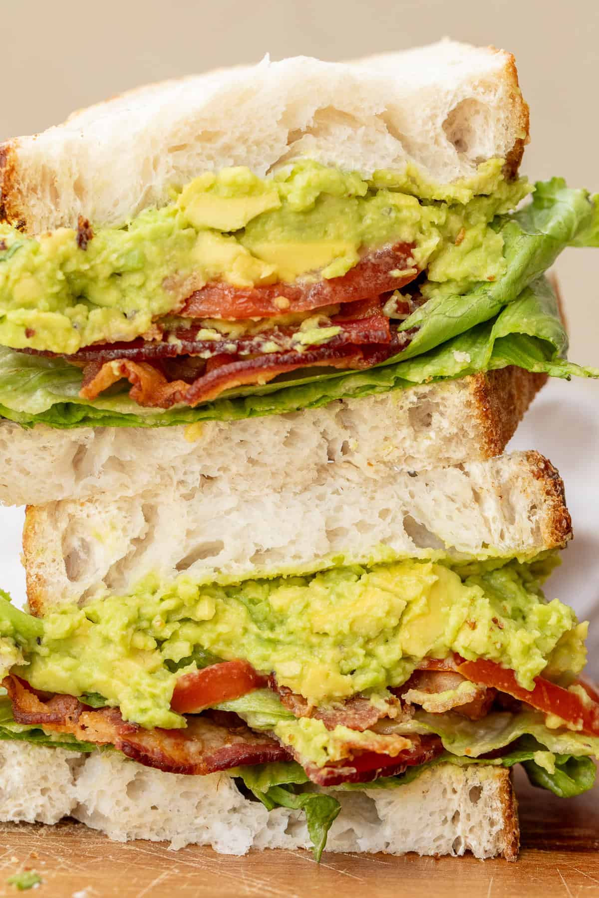 Make a homemade BLT sandwich with simple ingredients and the perfect balance of texture. A stacked blt sandwich showing the layers of creamy avocado spread, crispy bacon, and juicy tomatoes.