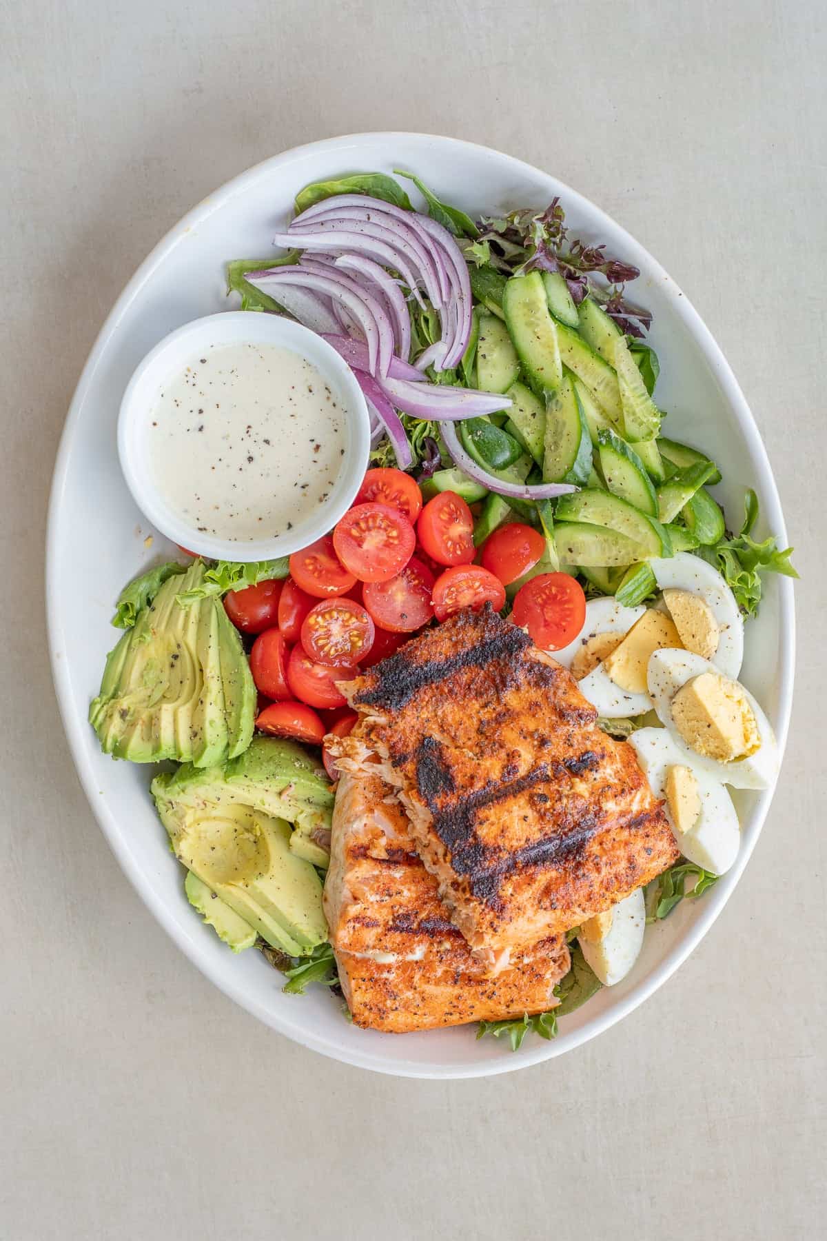 A fresh grilled salmon salad recipe that is easy to make for a healthy lunch or light dinner. A fresh salmon salad in a large salad bowl.