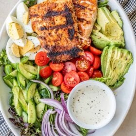 A large salad bowl with the grilled salmon salad.
