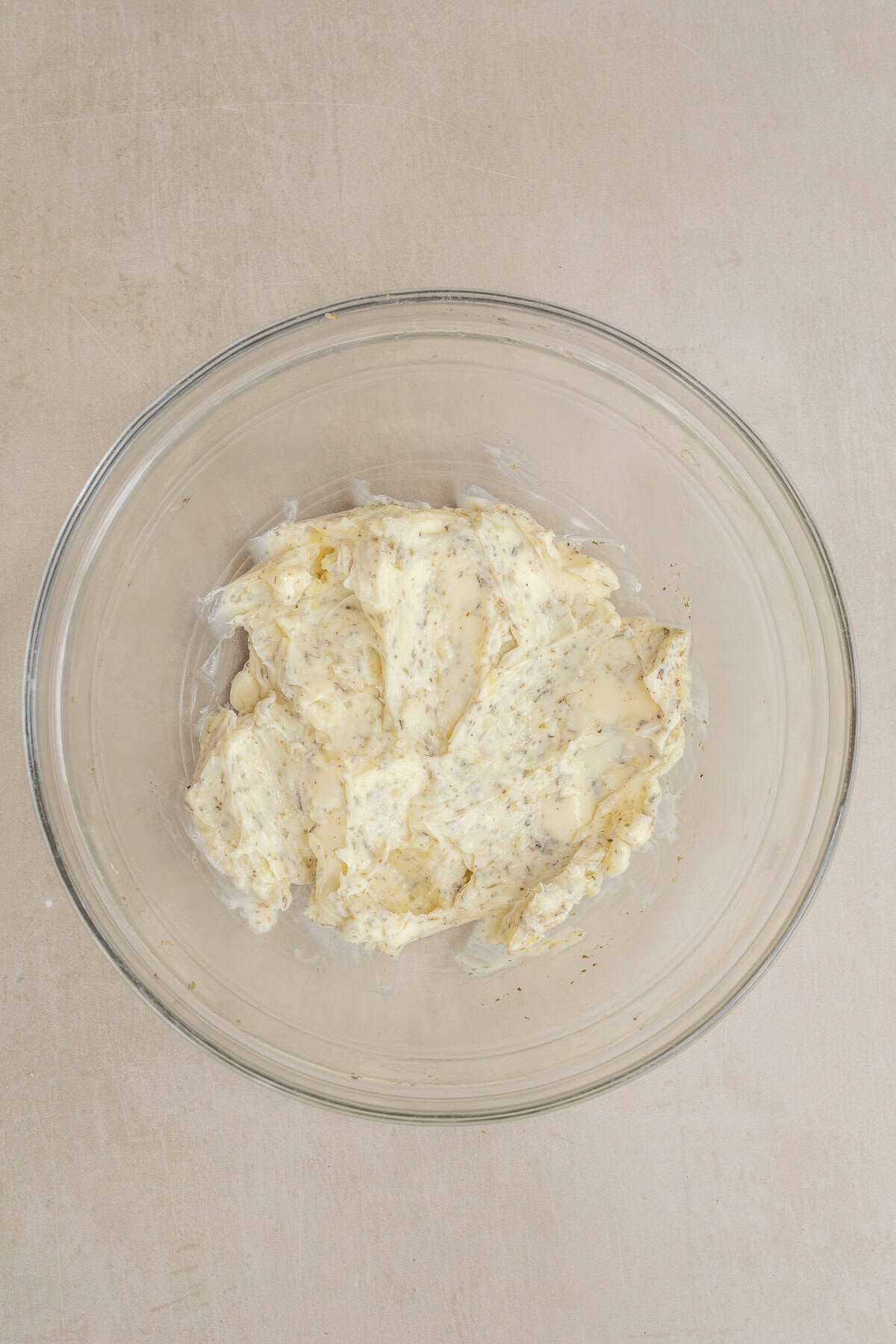 The Best Garlic Cheesy Bread Recipe A glass bowl with the compound butter for garlic cheesy bread.
